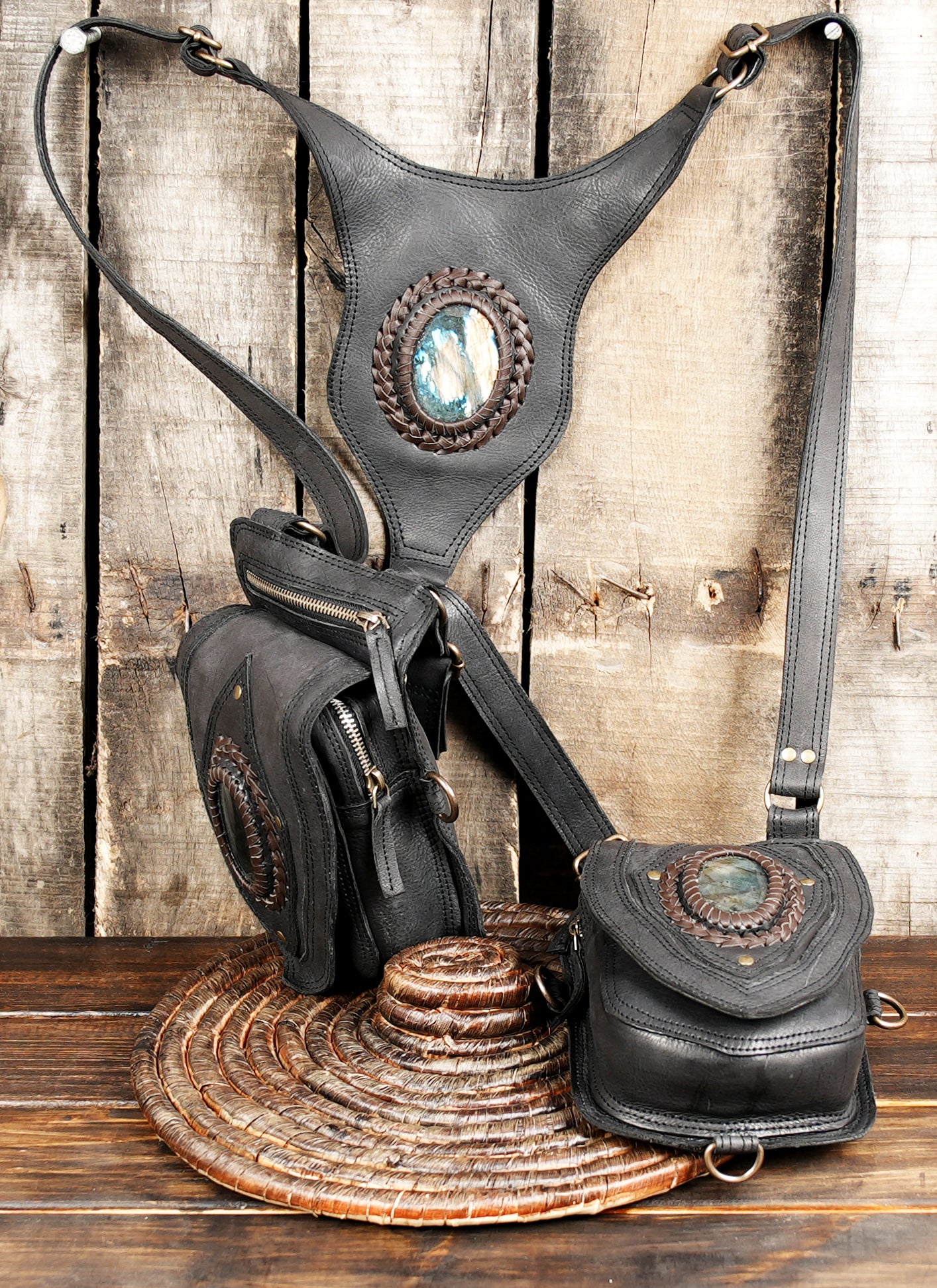 Adjustable black leather shoulder holster with gemstone inlay.