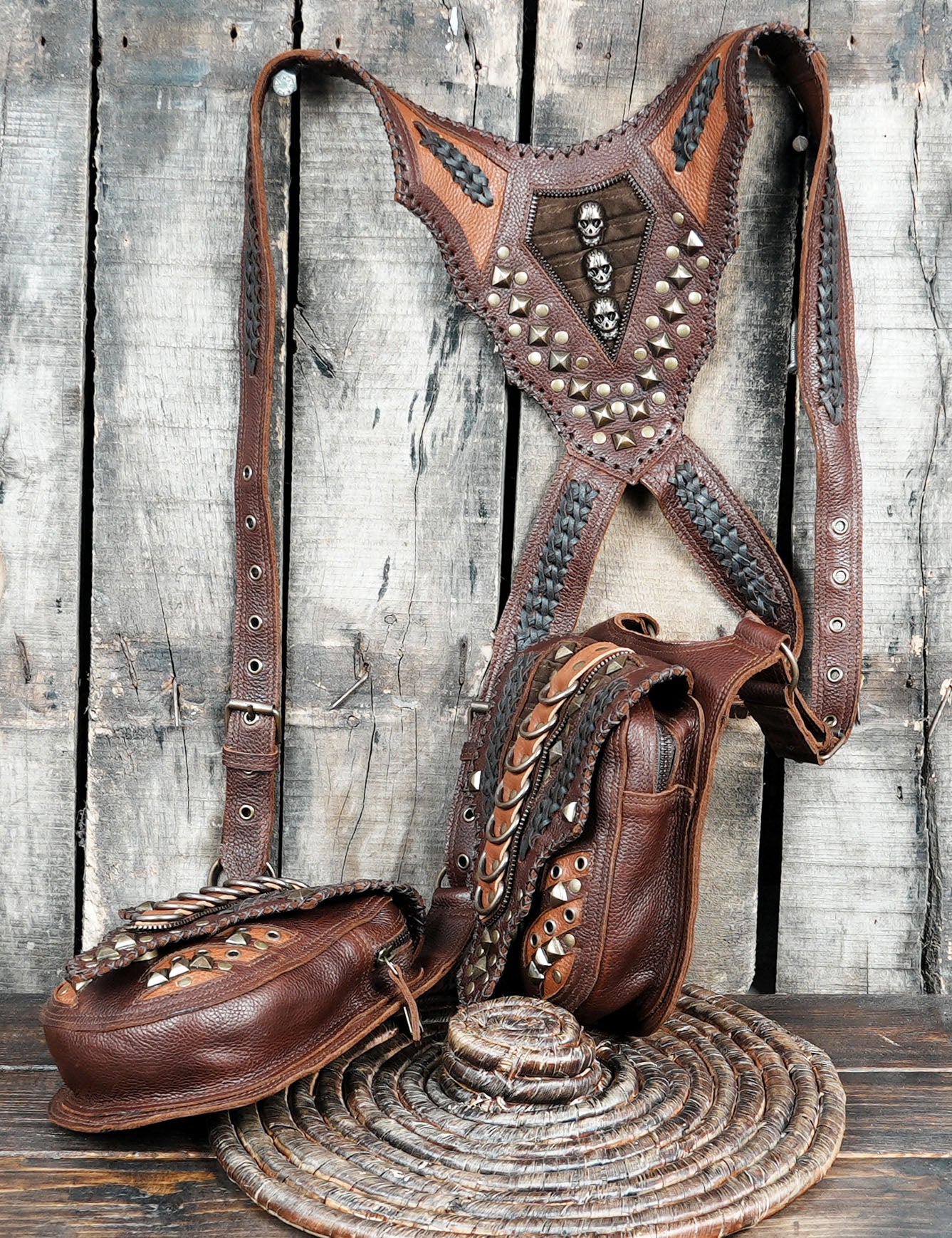 “Hand-tooled leather holster belt bag with rustic hardware and tribal patterns”