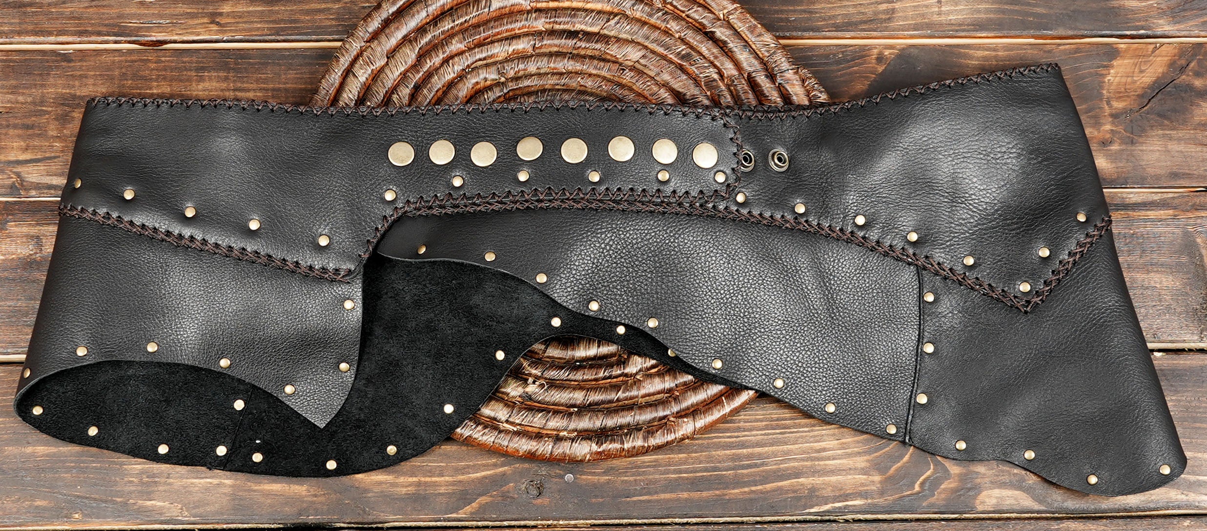 Rustic black leather skirt with decorative studs and stitched details