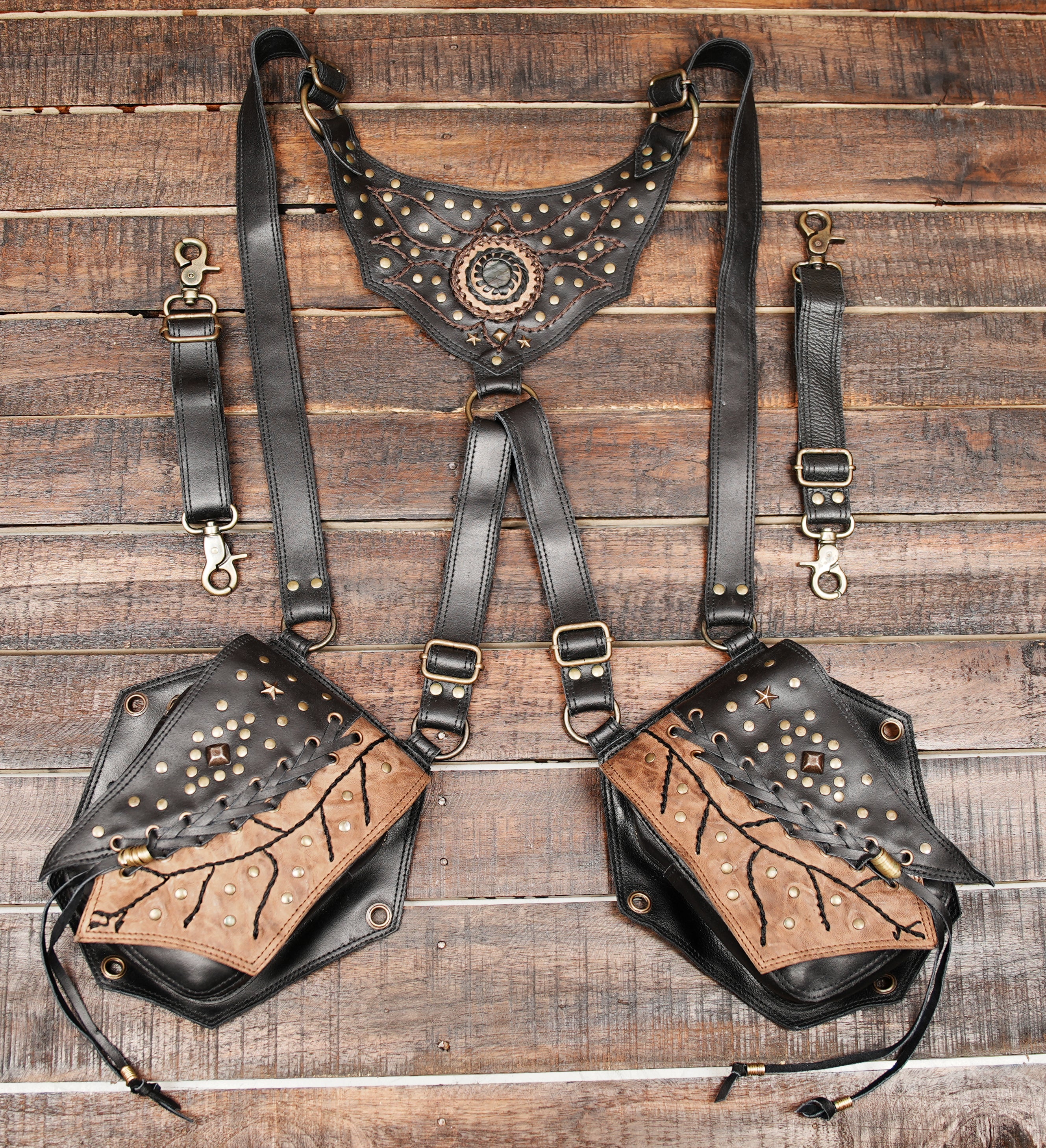 Featuring two spacious pouches with unique tribal-inspired patterns and decorative studs, it is perfect for carrying essentials like your phone, wallet, and keys while keeping your hands free.