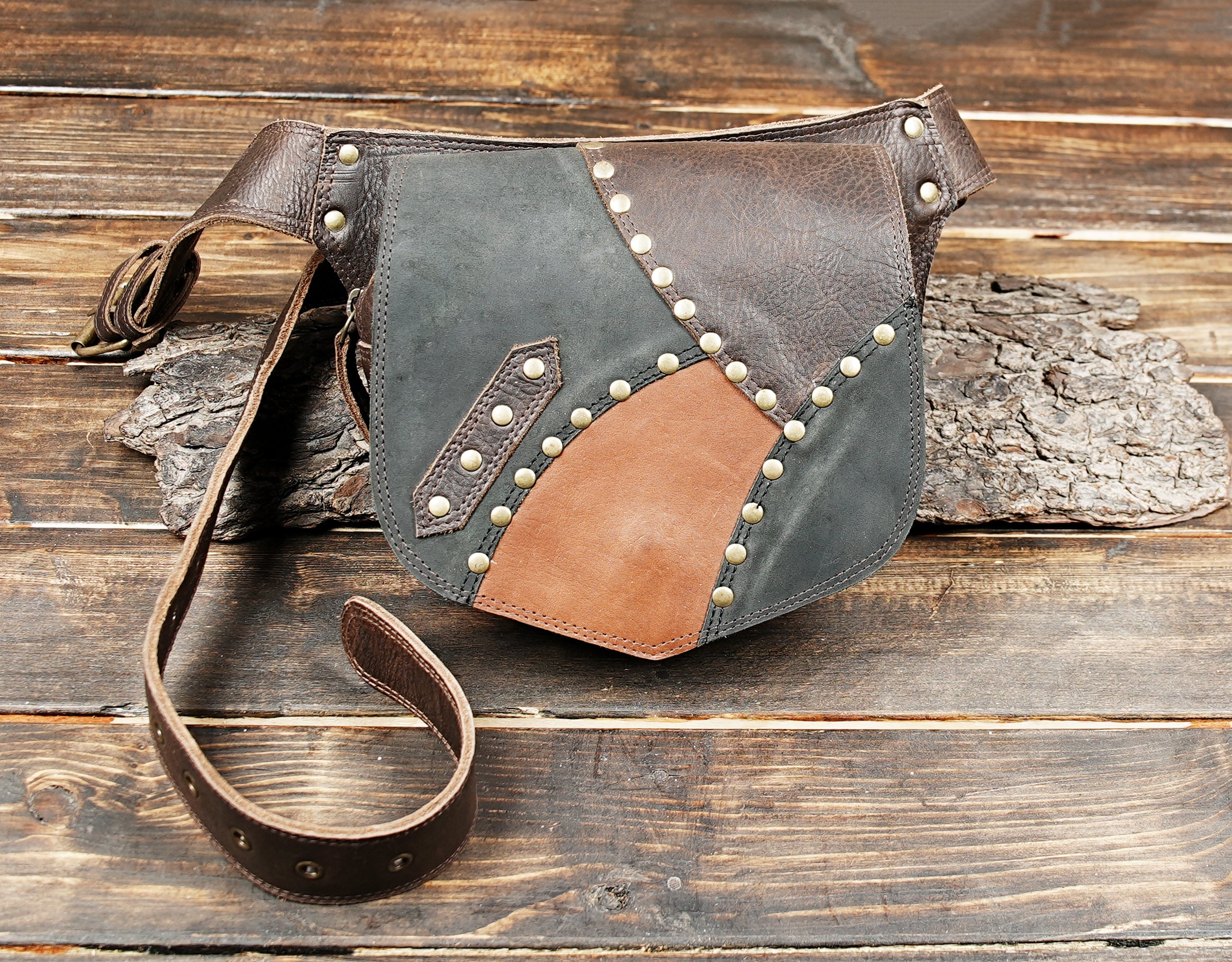 Side angle view of black and brown leather hip pouch