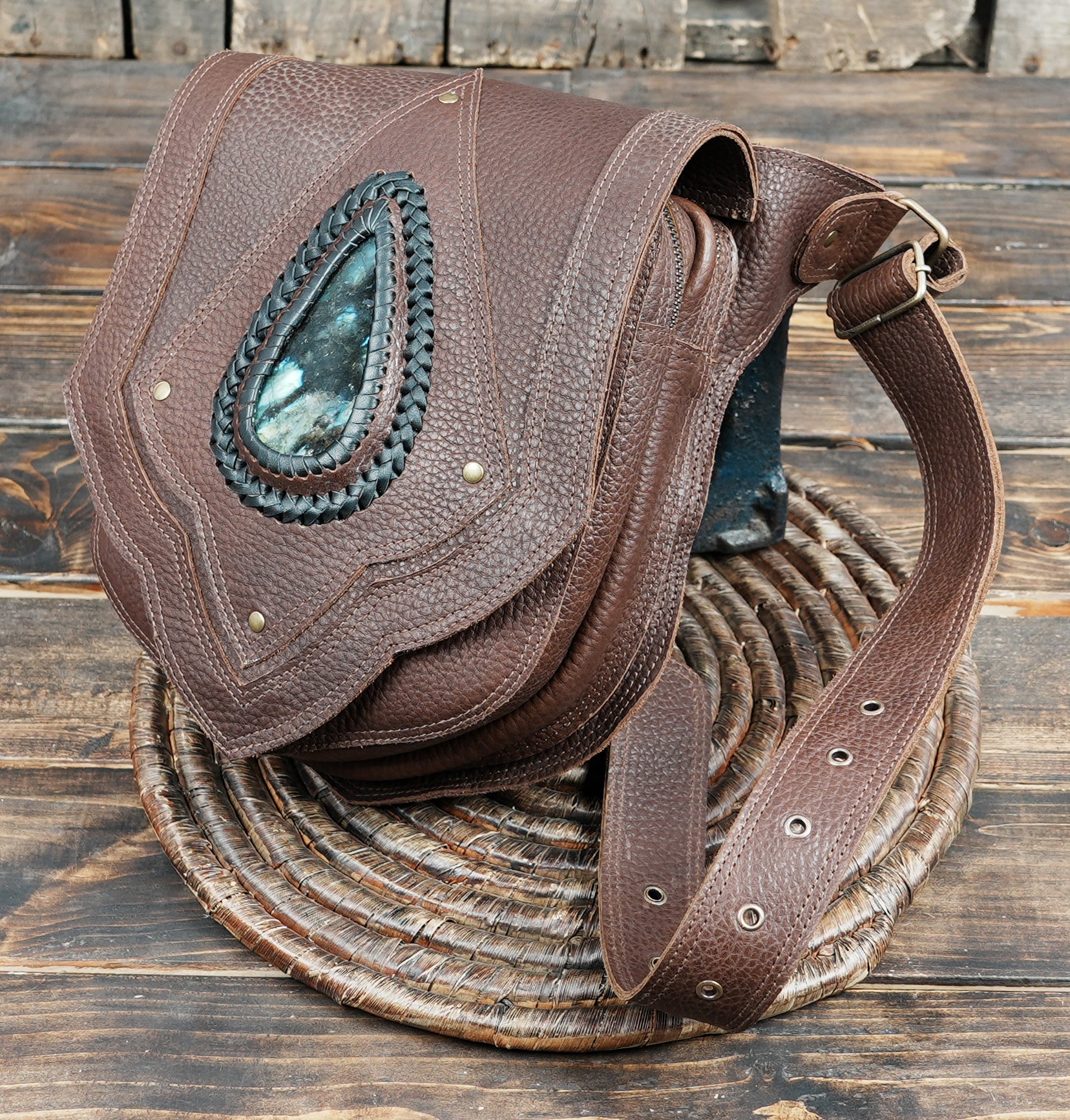 Artisan crafted leather waist bag with large center stone and layered panel design