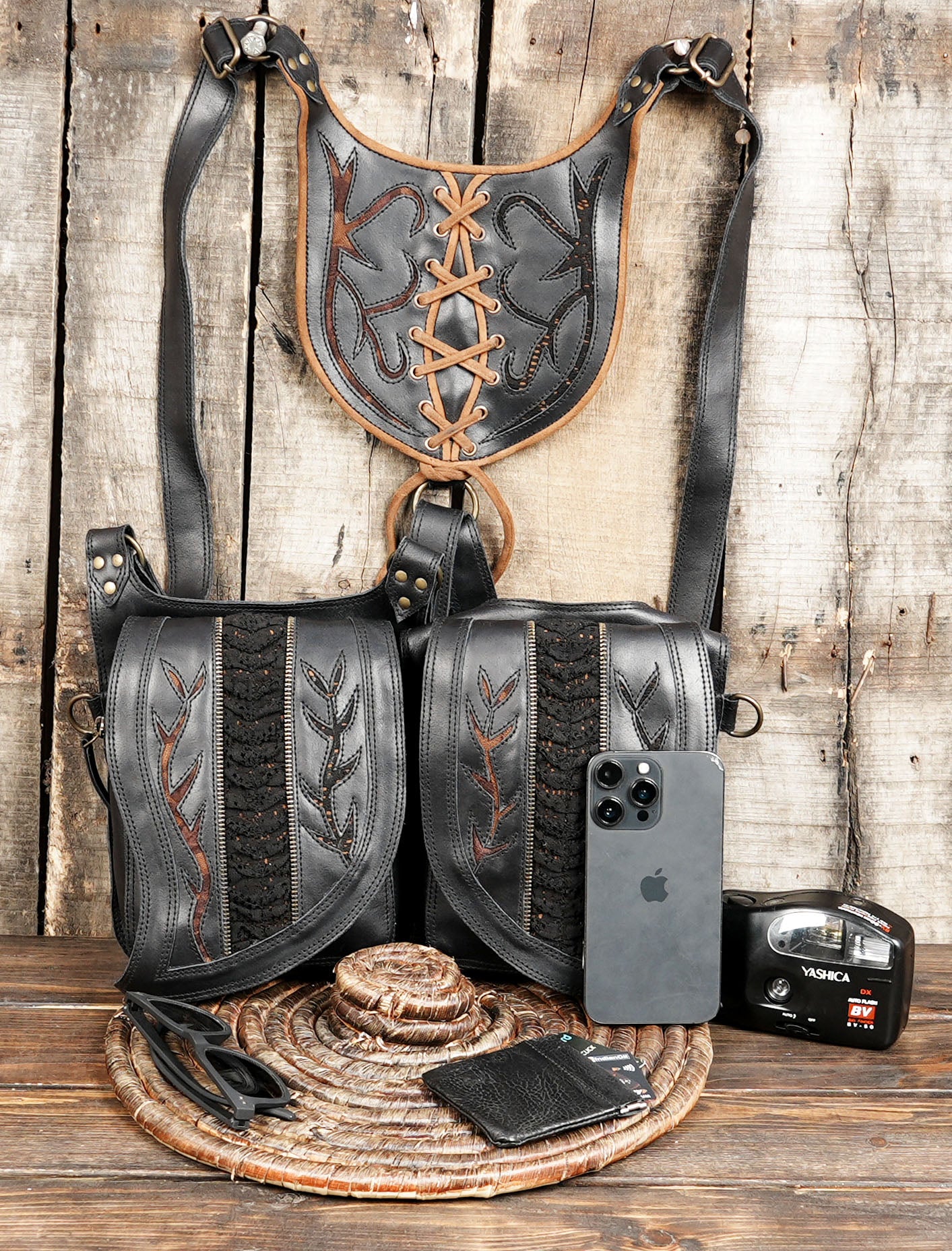 The holster showcases unique lace-up and stitched detailing on both the shoulder panel and pouches, giving it a tribal, gothic, and steampunk-inspired aesthetic.