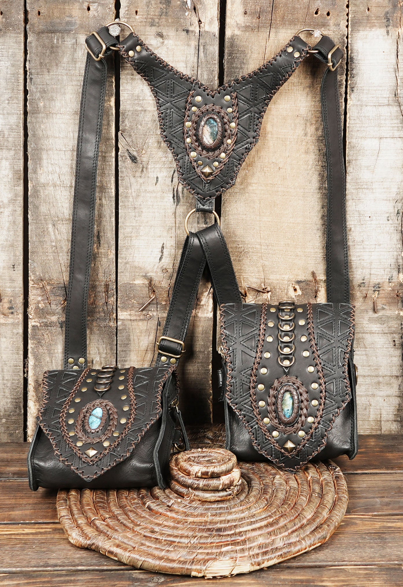 “Studded black leather holster bag set with geometric carvings and stone decor”
