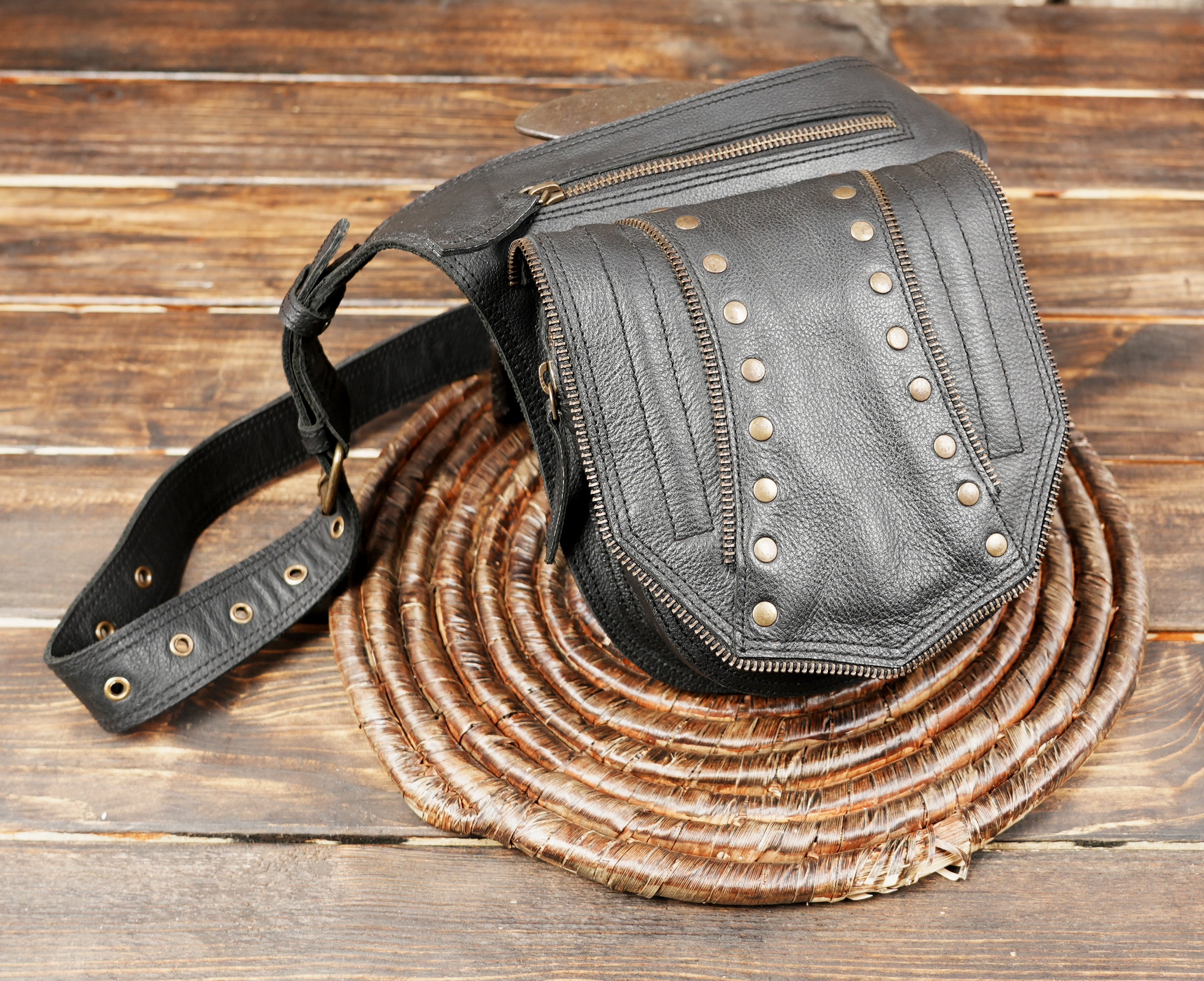 Rugged black leather hip bag styled for travel