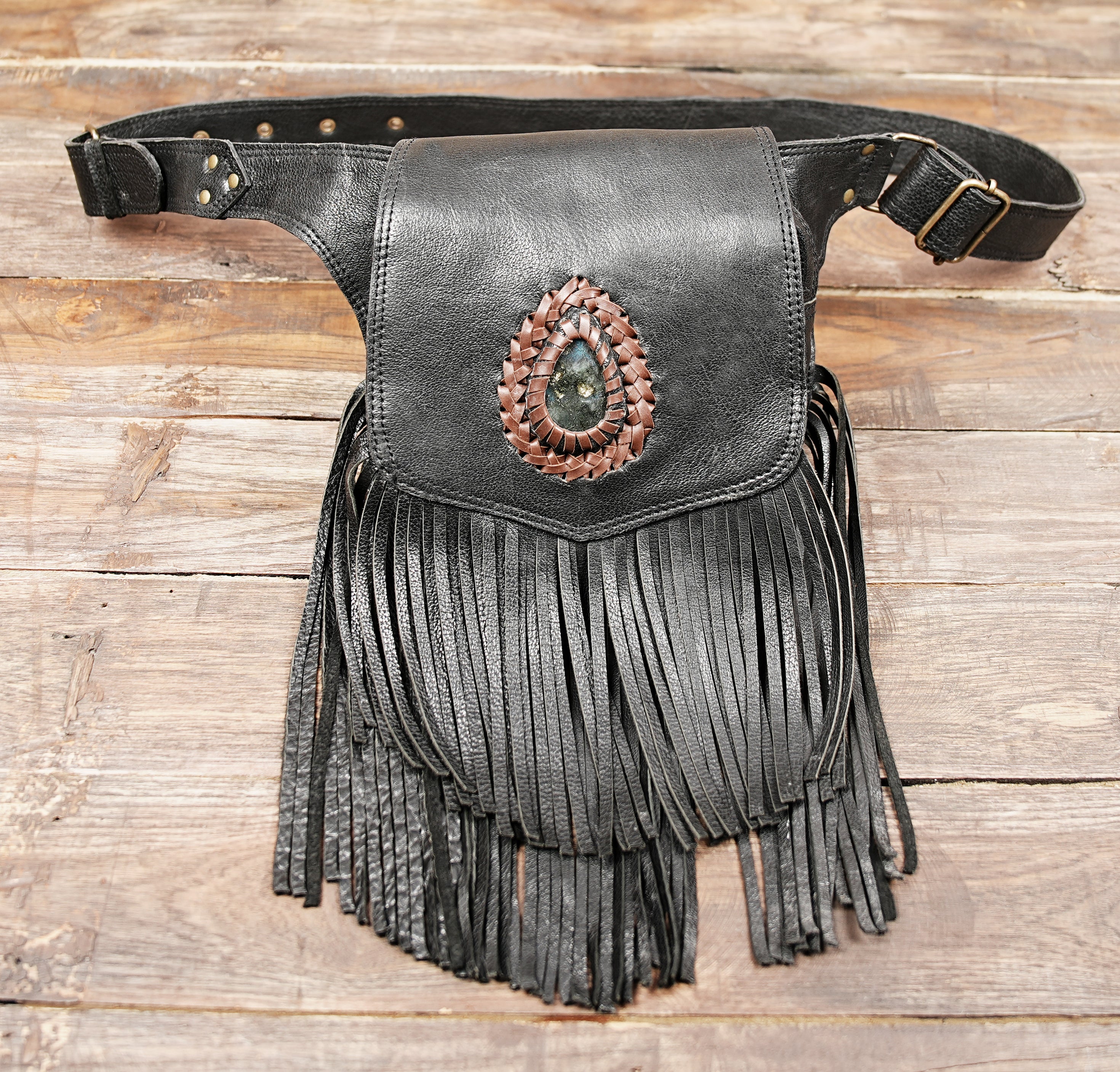 fringe leather hip pouch with adjustable strap worn on mannequin