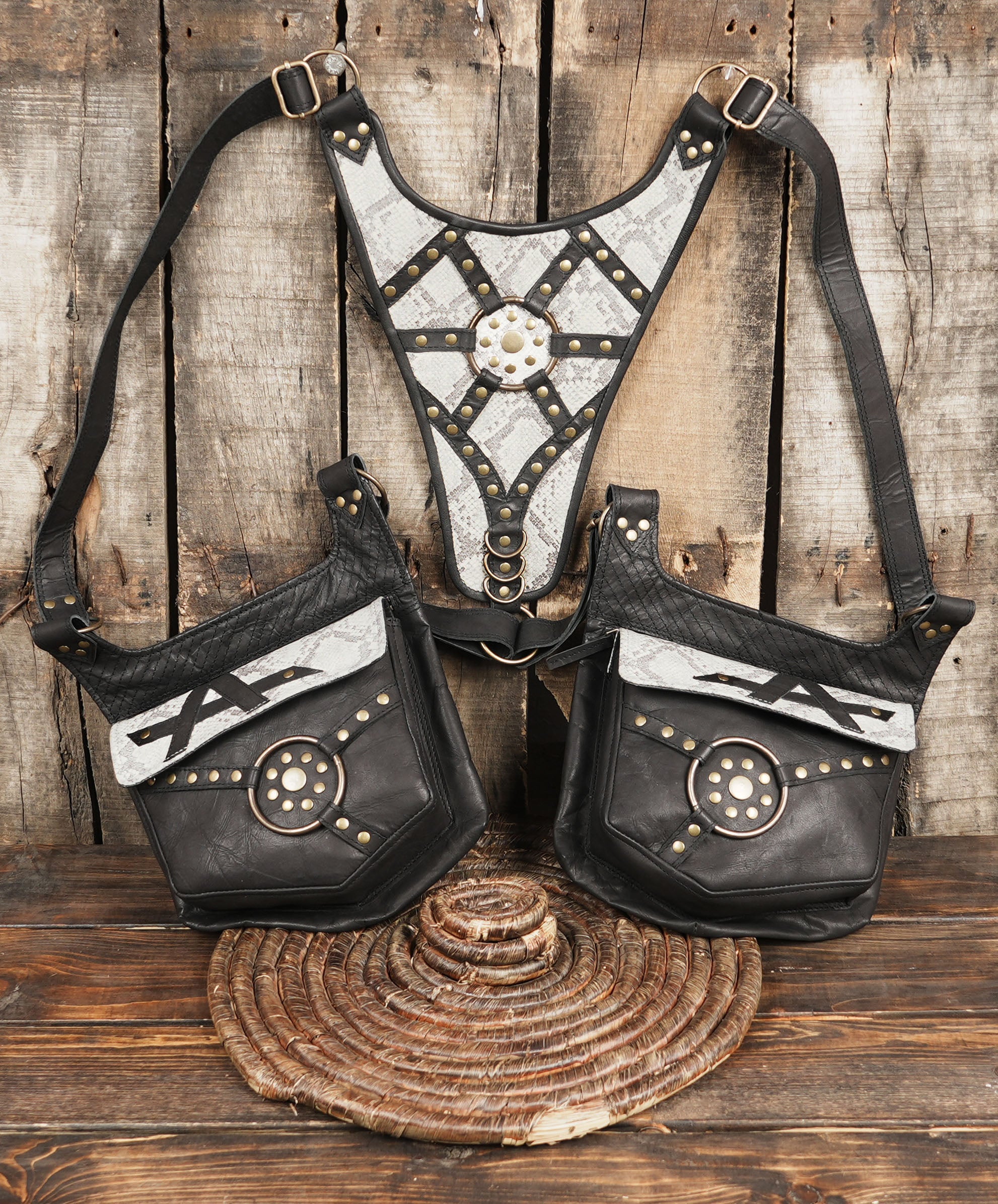 Artisan snakeskin leather holster with adjustable straps and side pouches.