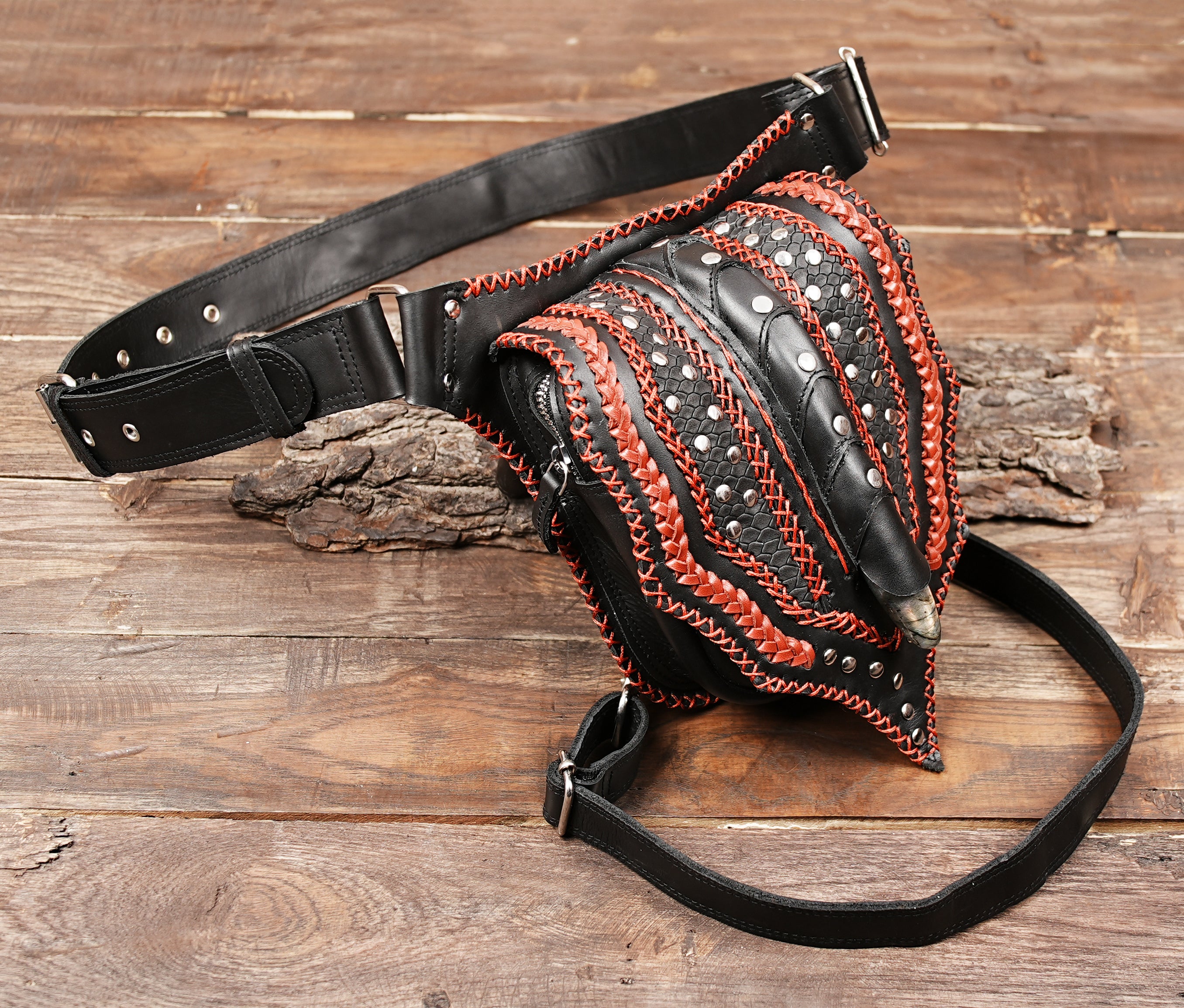 Statement black leather belt bag with intricate red handwoven design