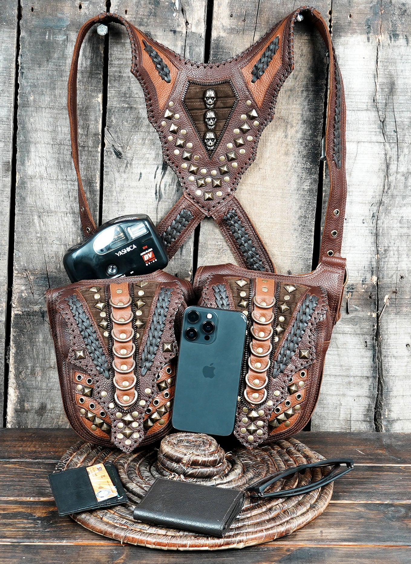 “Steampunk leather holster harness with decorative studs and braided textures”