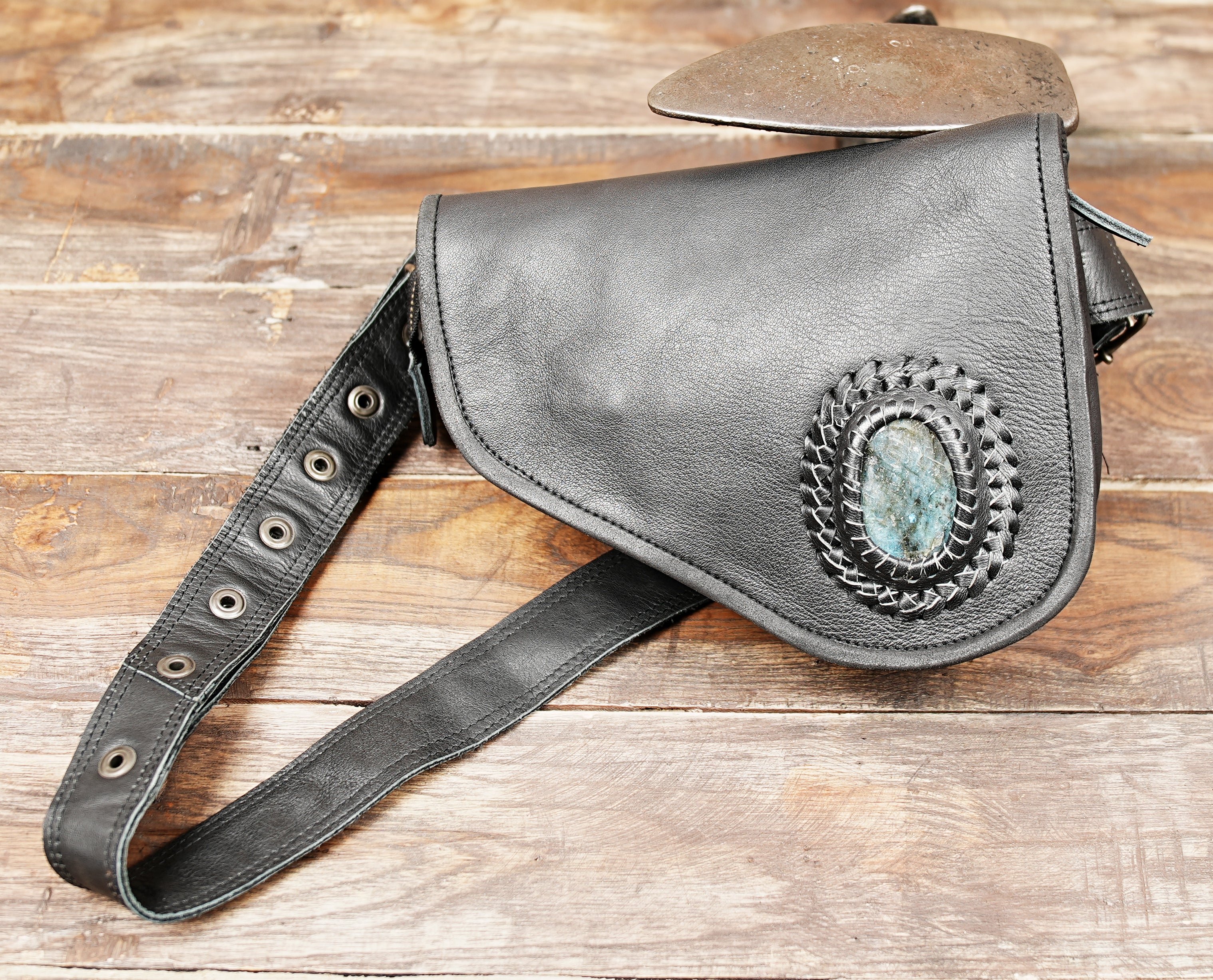 Black leather waist bag with gemstone worn by male model