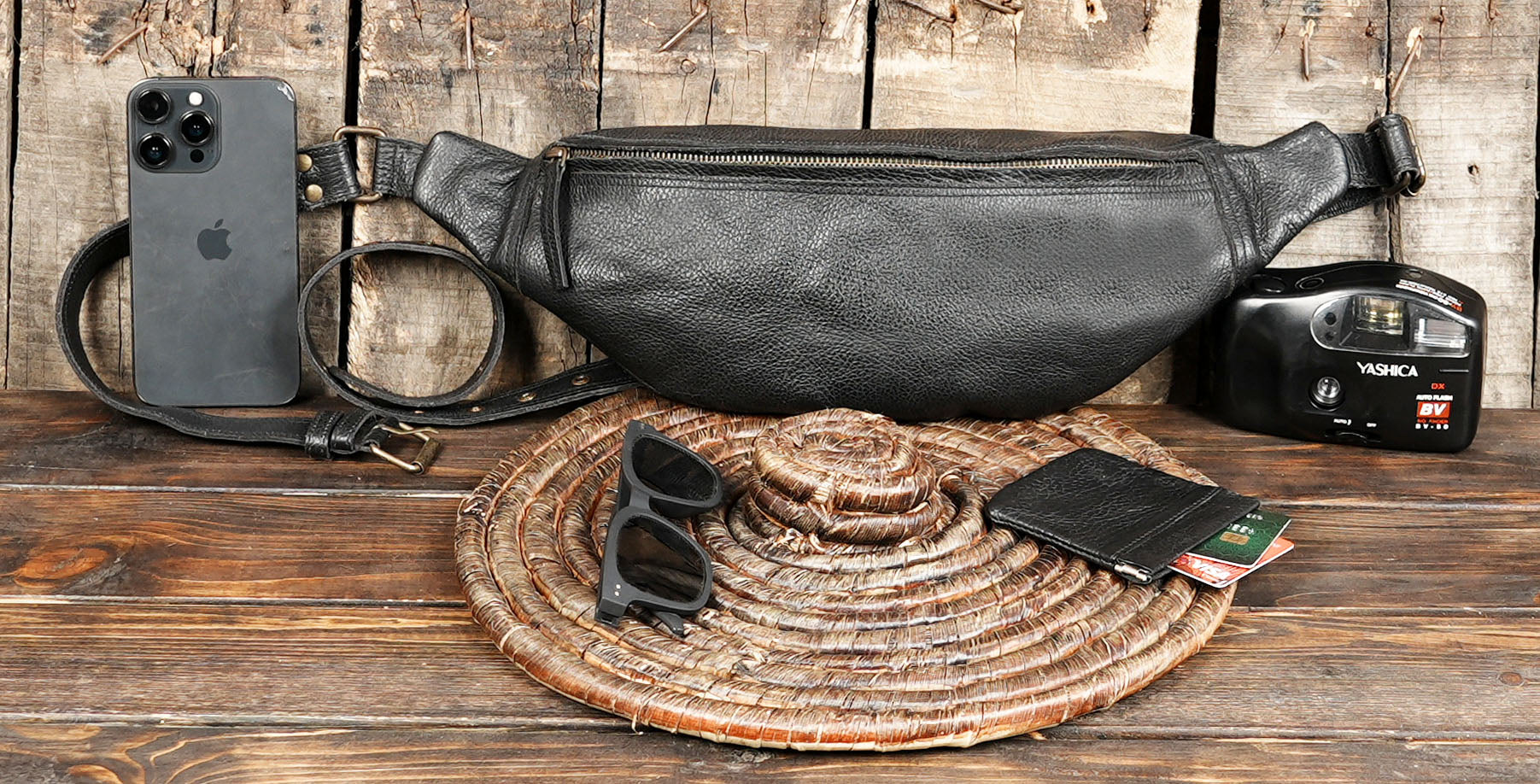 Black leather bum bag with durable strap and metal hardware