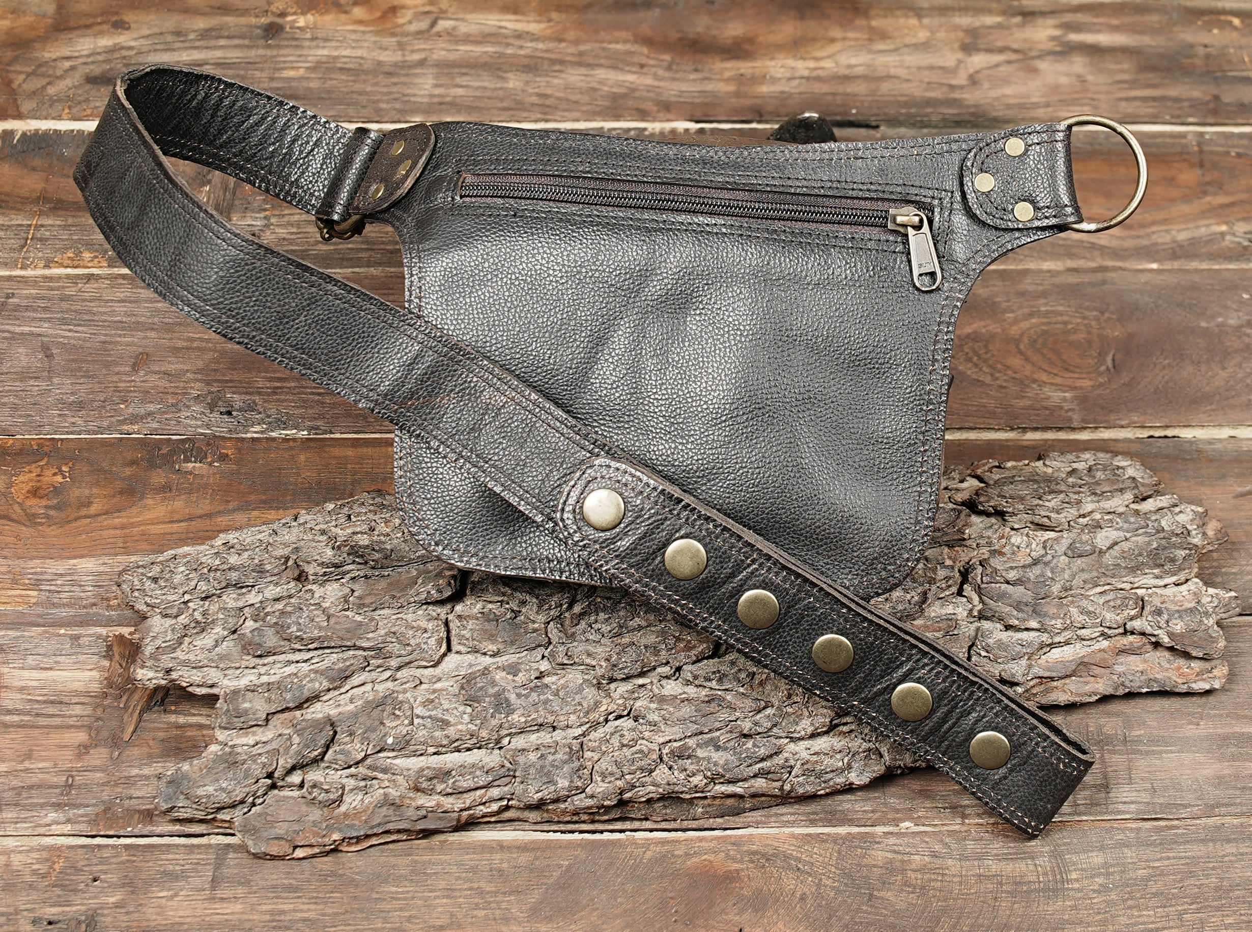 Black leather hip bag worn by female model