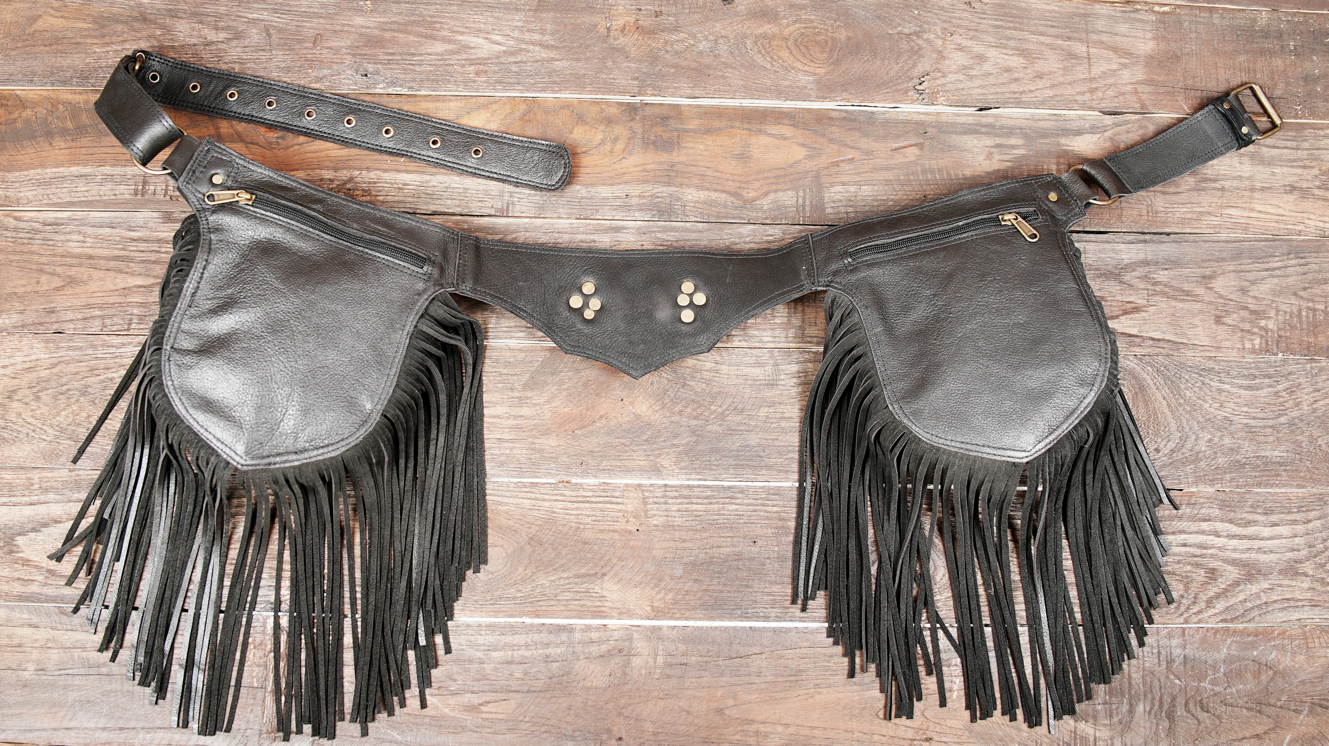 Side view of leather belt bag with hanging fringe
