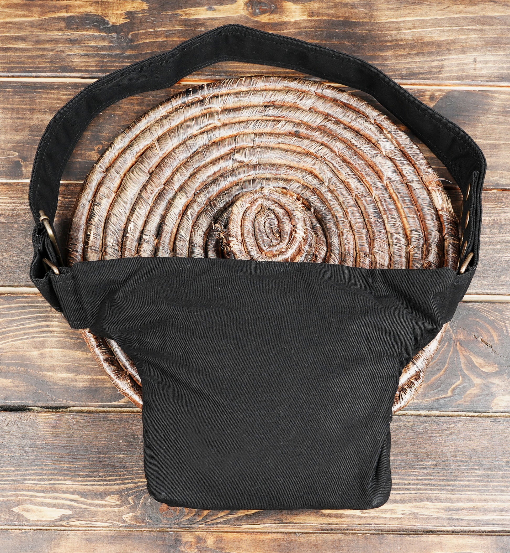 Model wearing black canvas waist bag with brass studs