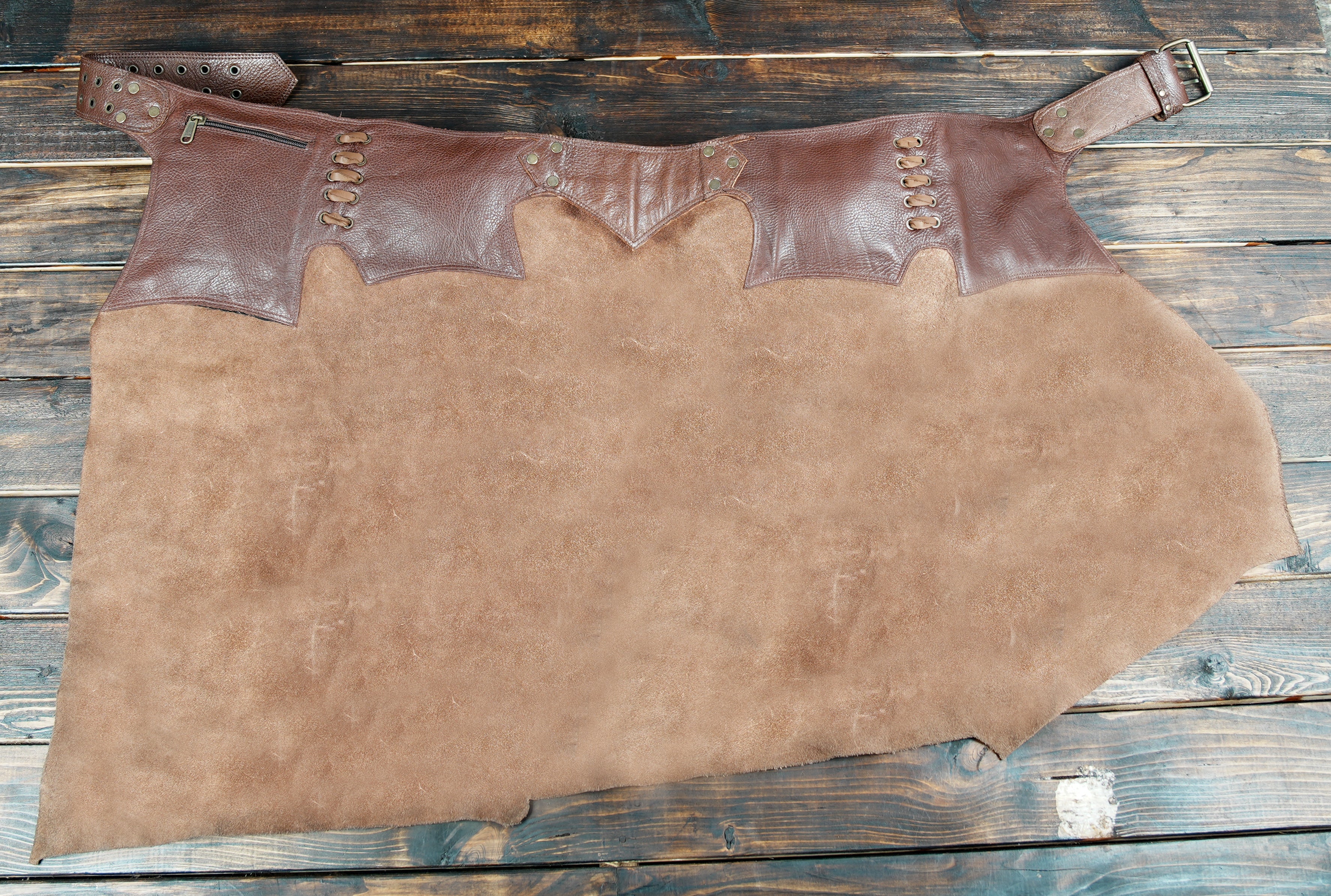Steampunk-inspired leather skirt with wide adjustable belt and secure storage pockets.