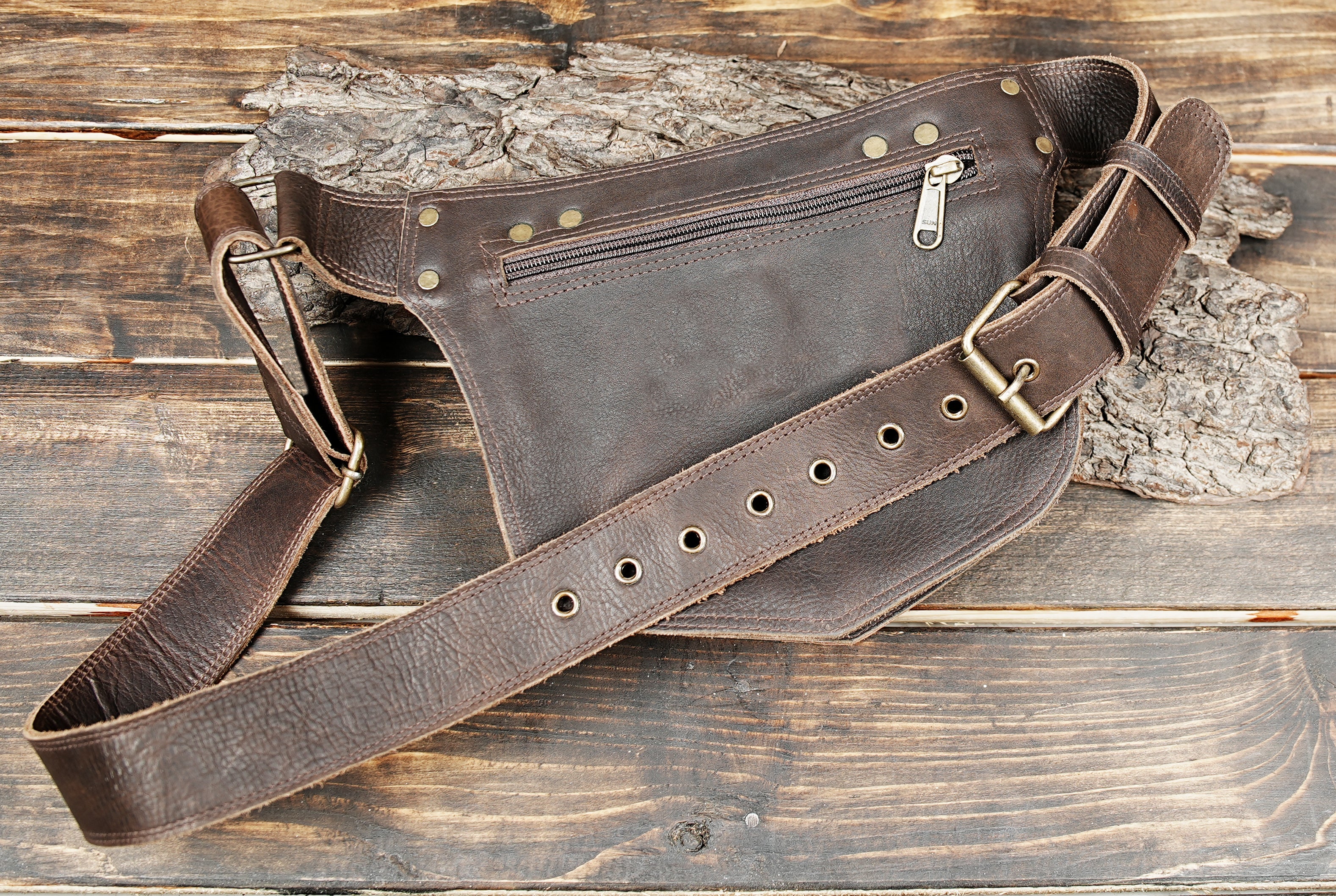 Brown leather waist bag with brass studs and detailed stitching