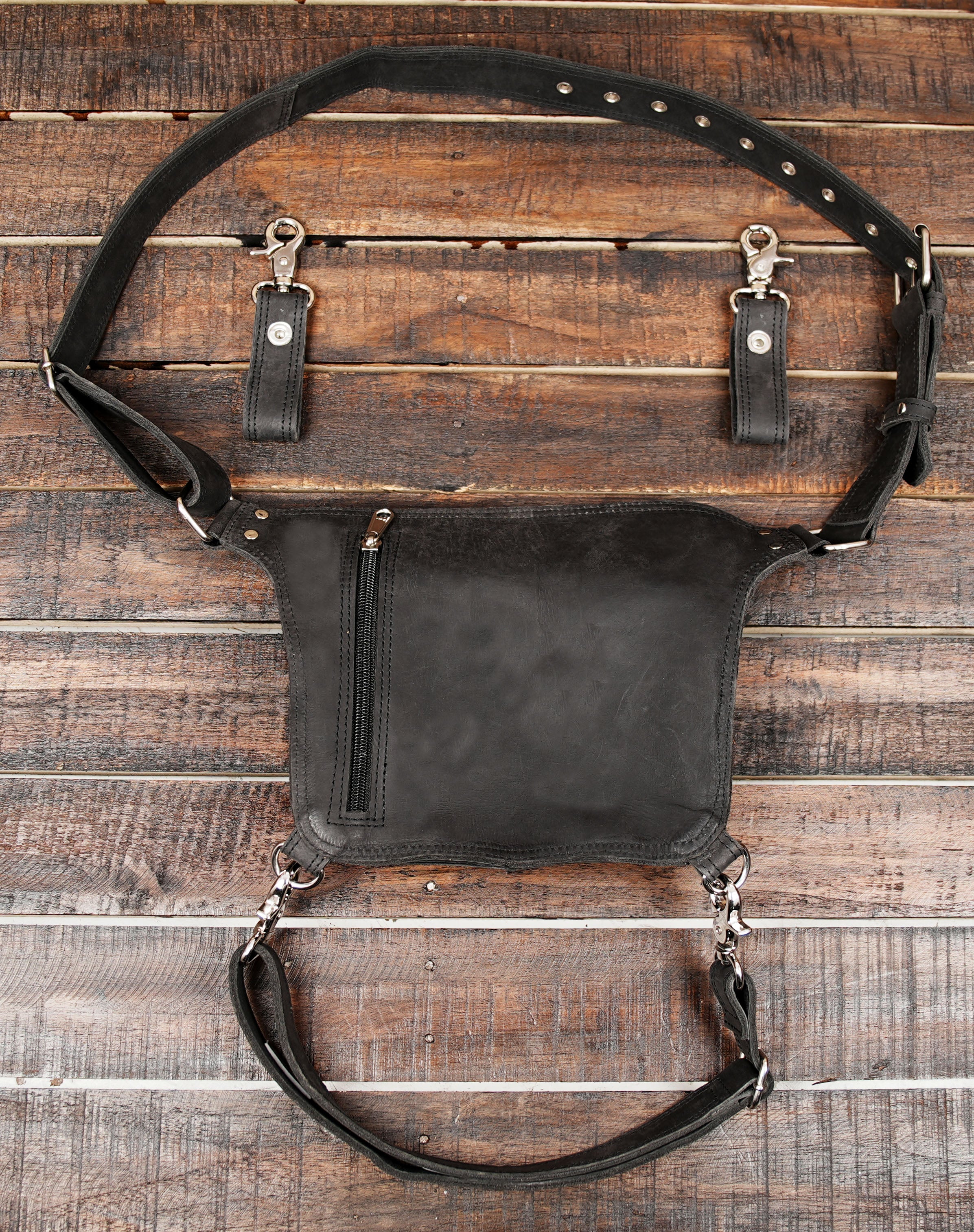 Crafted from premium genuine leather, it features a detachable thigh strap and a spacious utility pouch secured with a snap-button flap, making it ideal for keeping essentials like your phone, wallet, keys, or tools safe while staying hands-free.