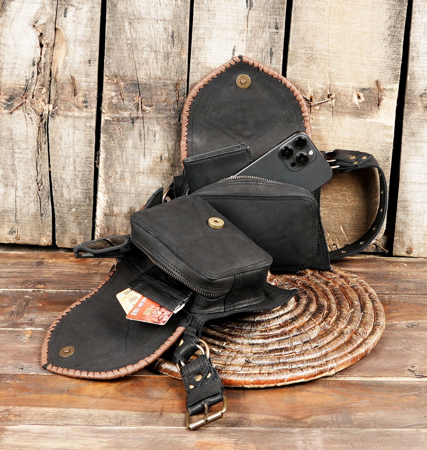 Gemstone leather utility belt displayed on rustic wood background