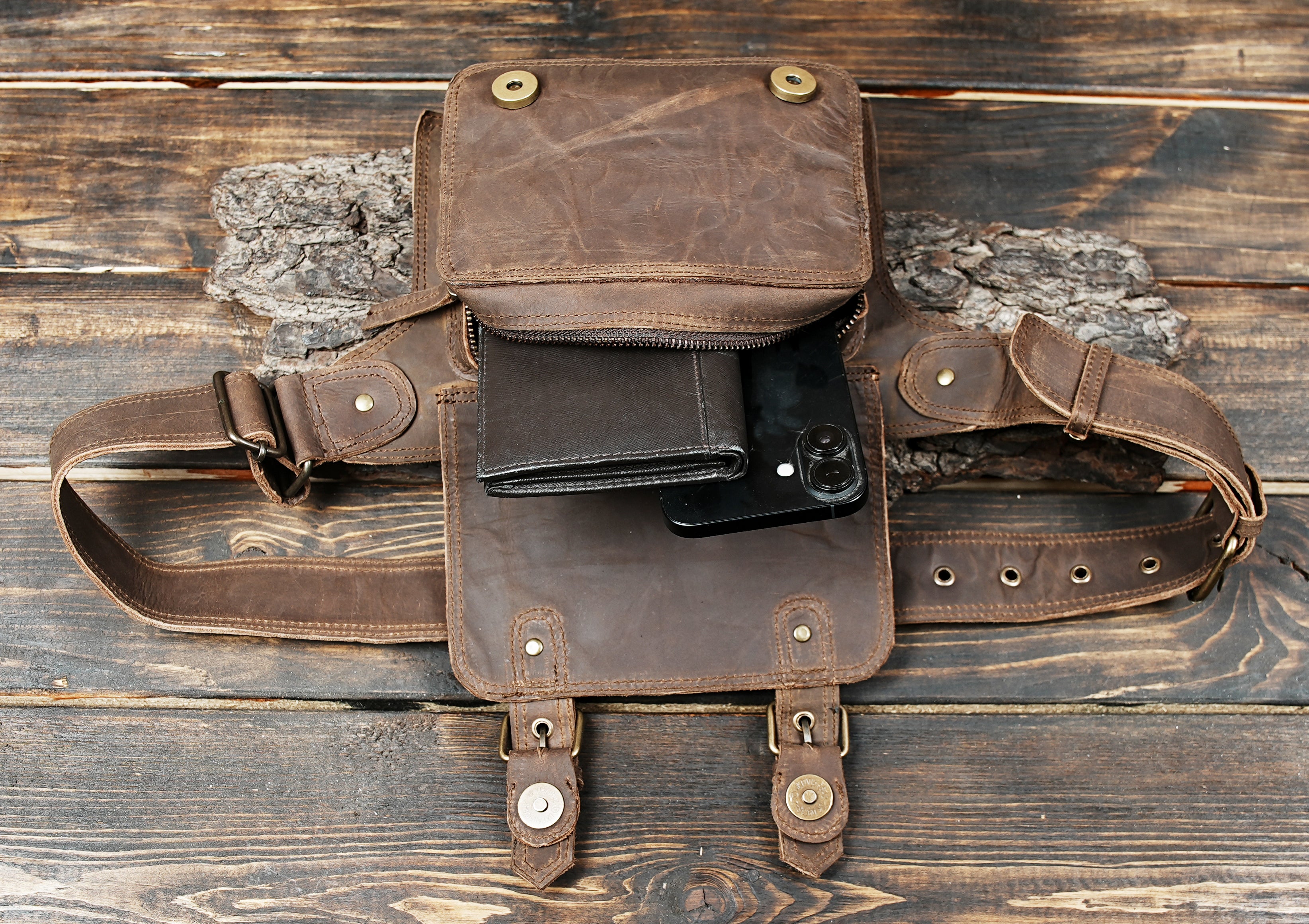 Side view of brown leather fanny pack with adjustable belt