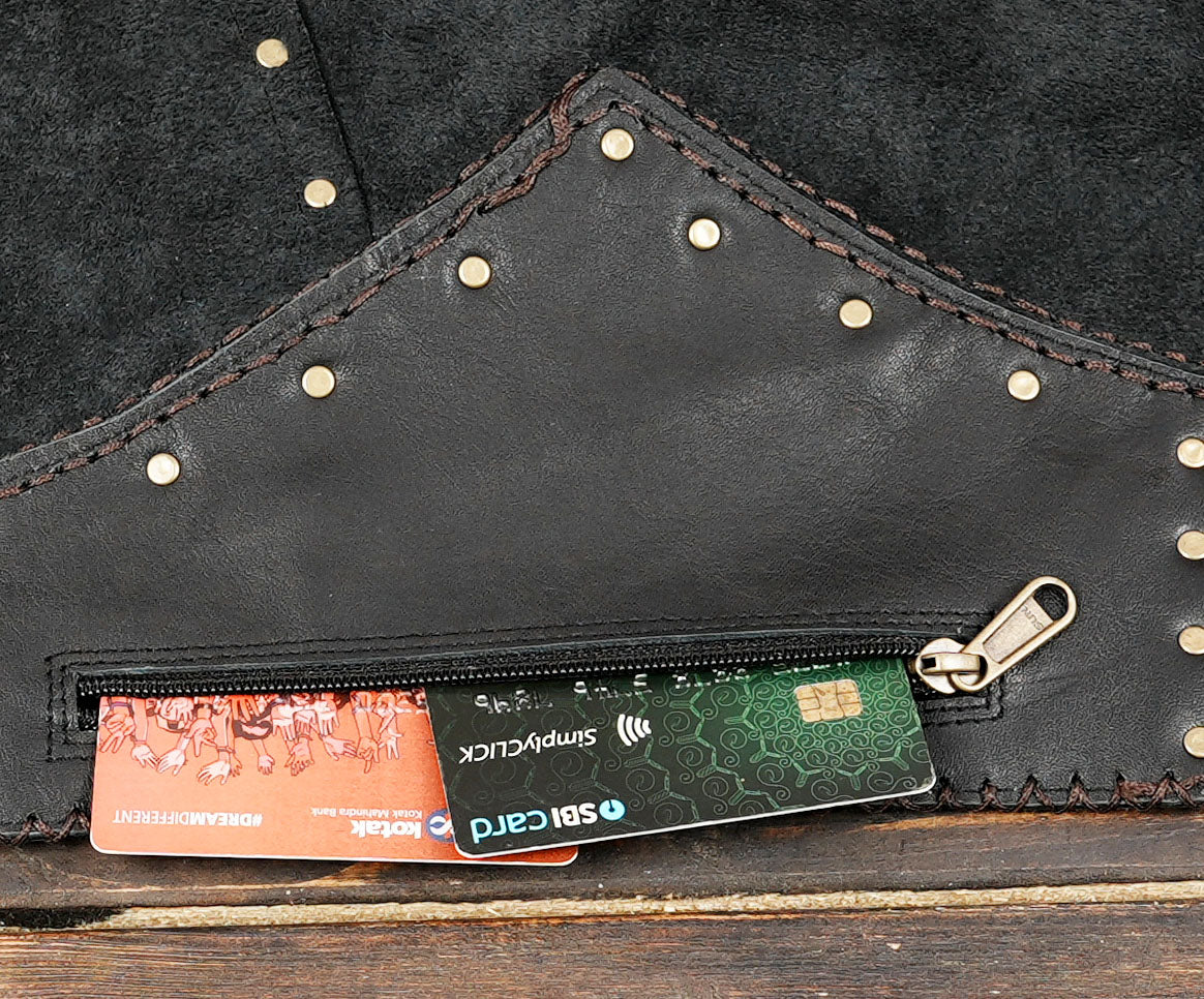 Cowboy-inspired black leather skirt with metal stud accents