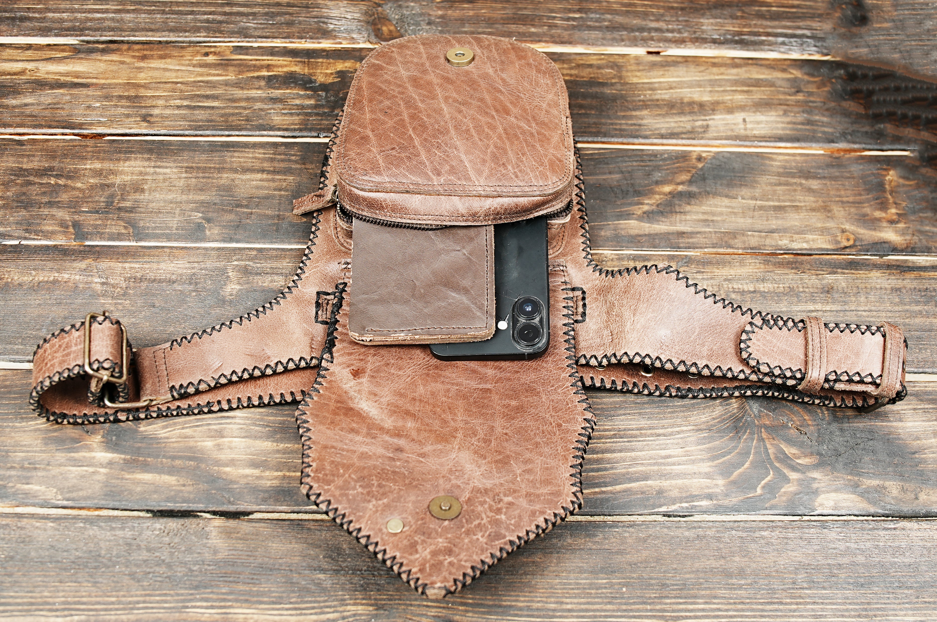 Rustic brown leather belt bag with gemstone centerpiece and black trim
