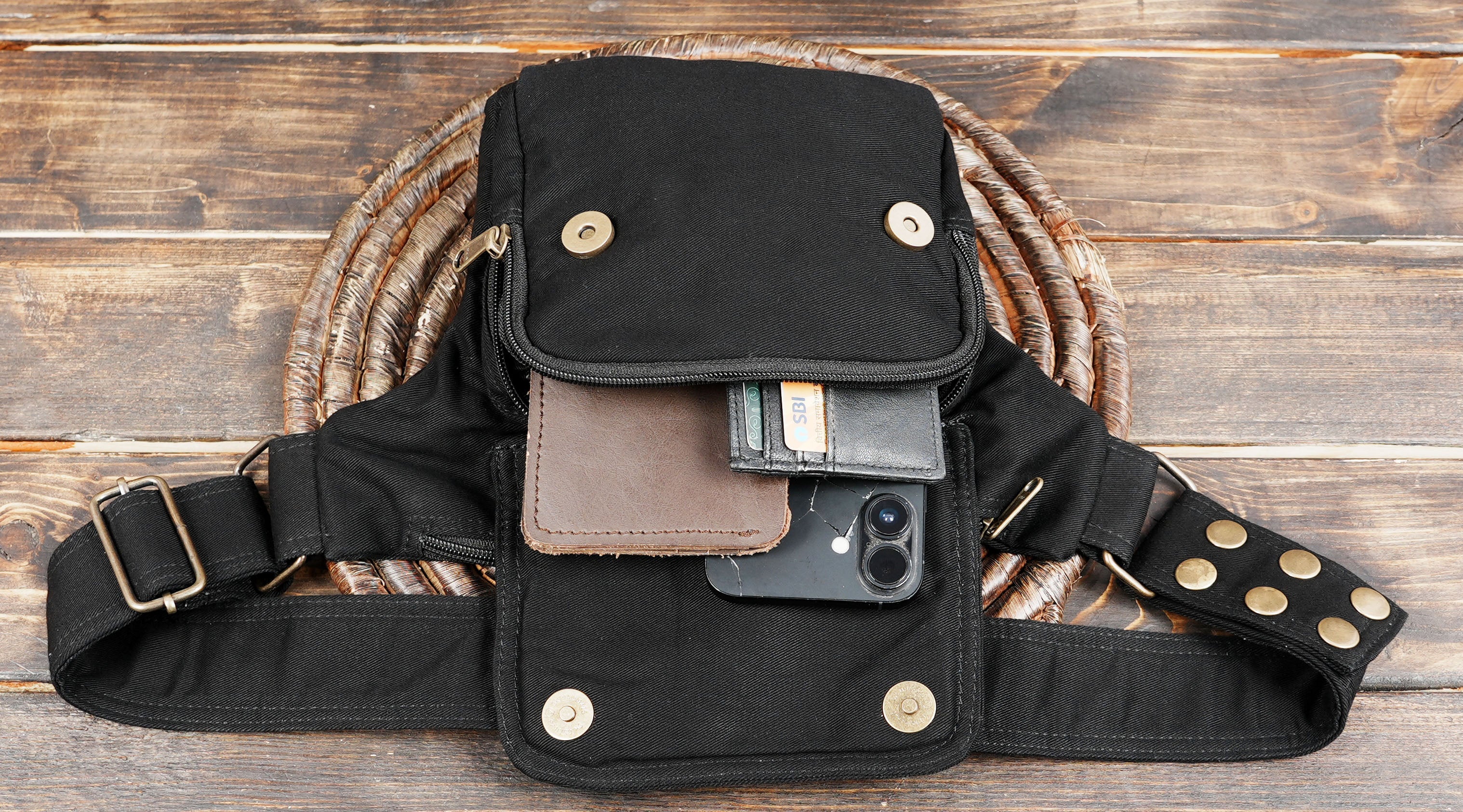 Front view of black utility fanny pack with zippered pockets