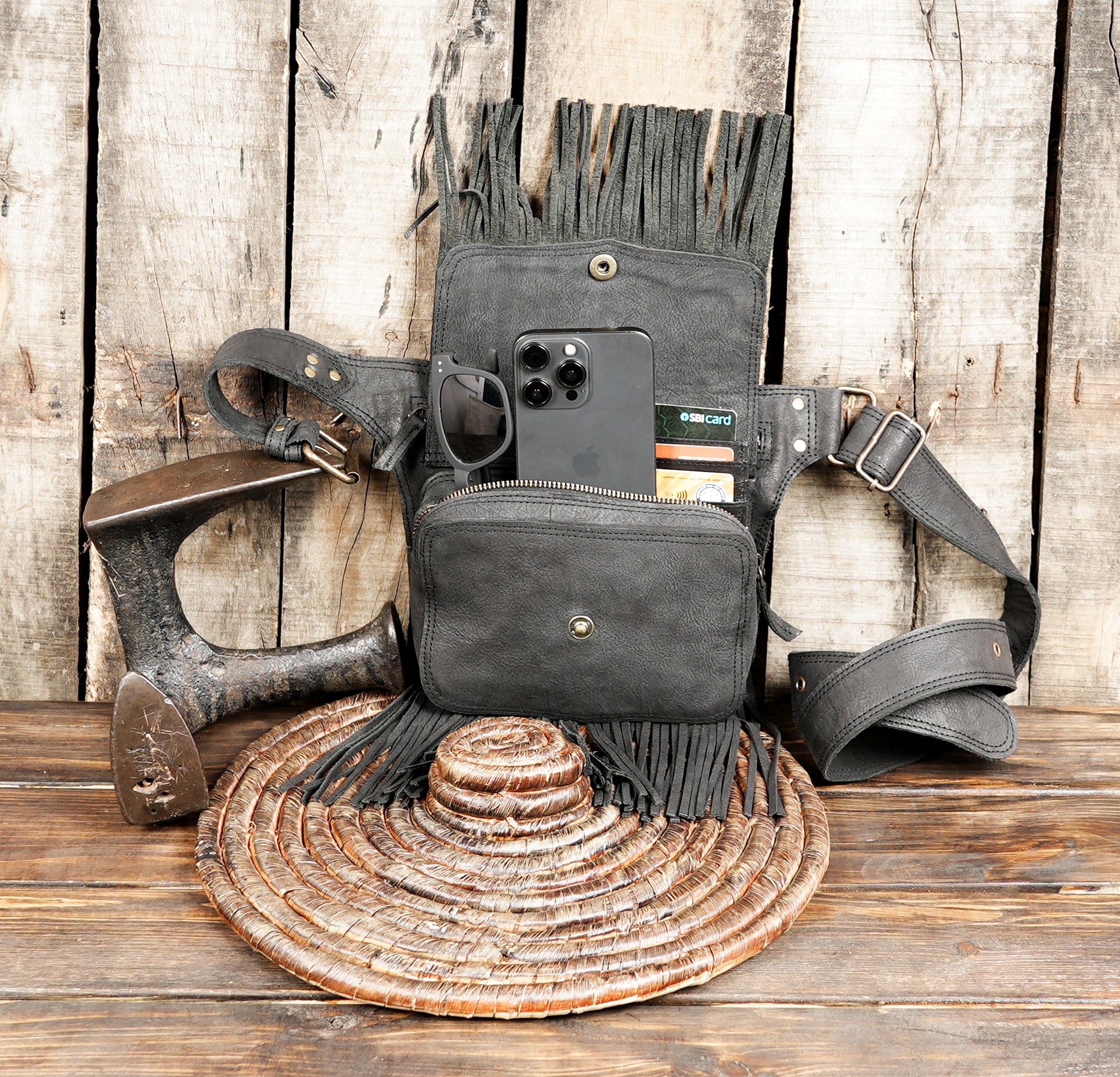 Festival-ready leather belt bag with fringe design and brass button closure