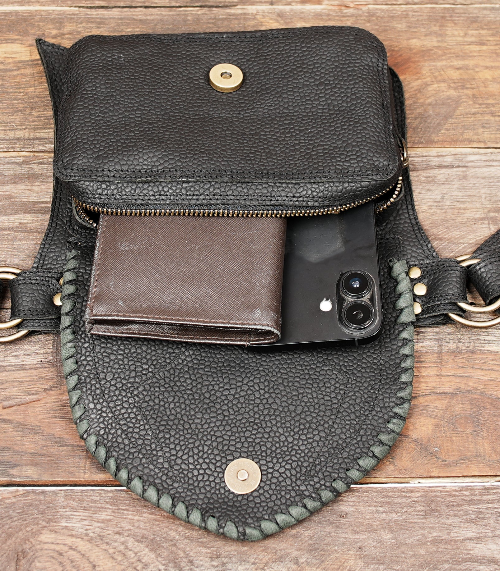 Black gemstone leather festival belt displayed on rustic wood surface