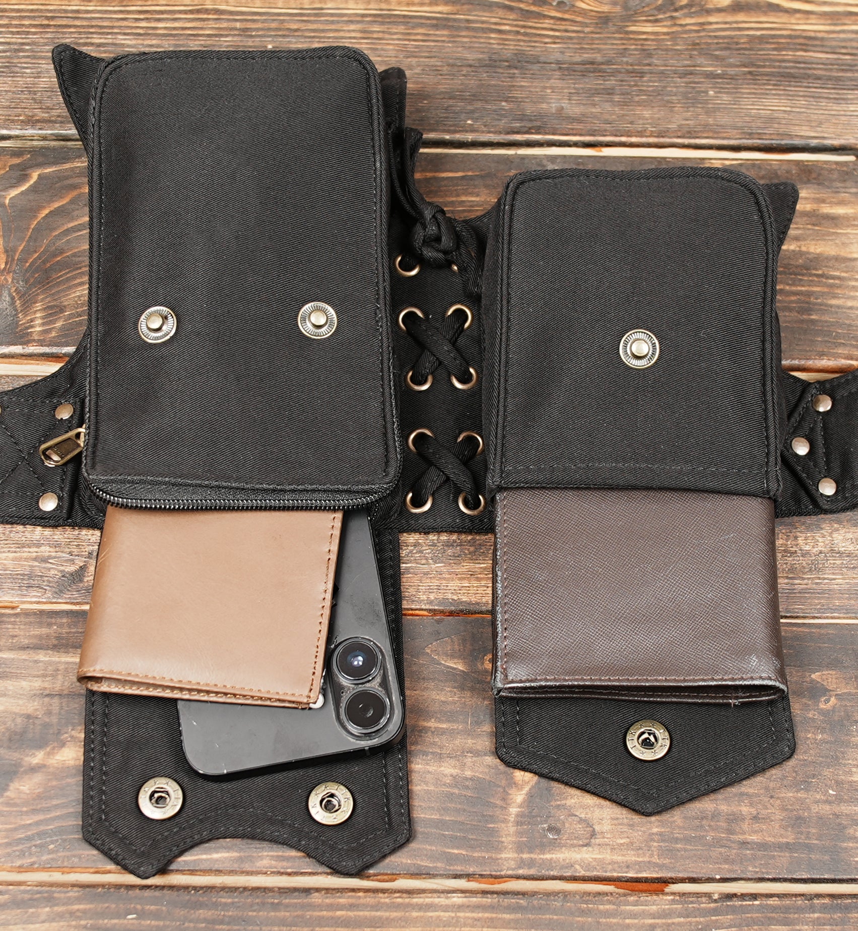 Black leather pocket belt bag laid flat with adjustable straps