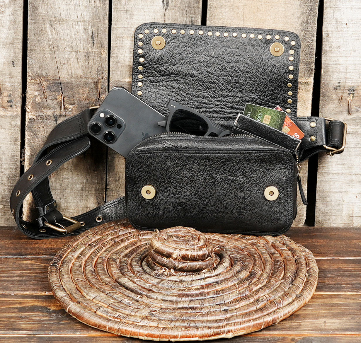 Boho-chic black leather festival bag with adjustable waist strap