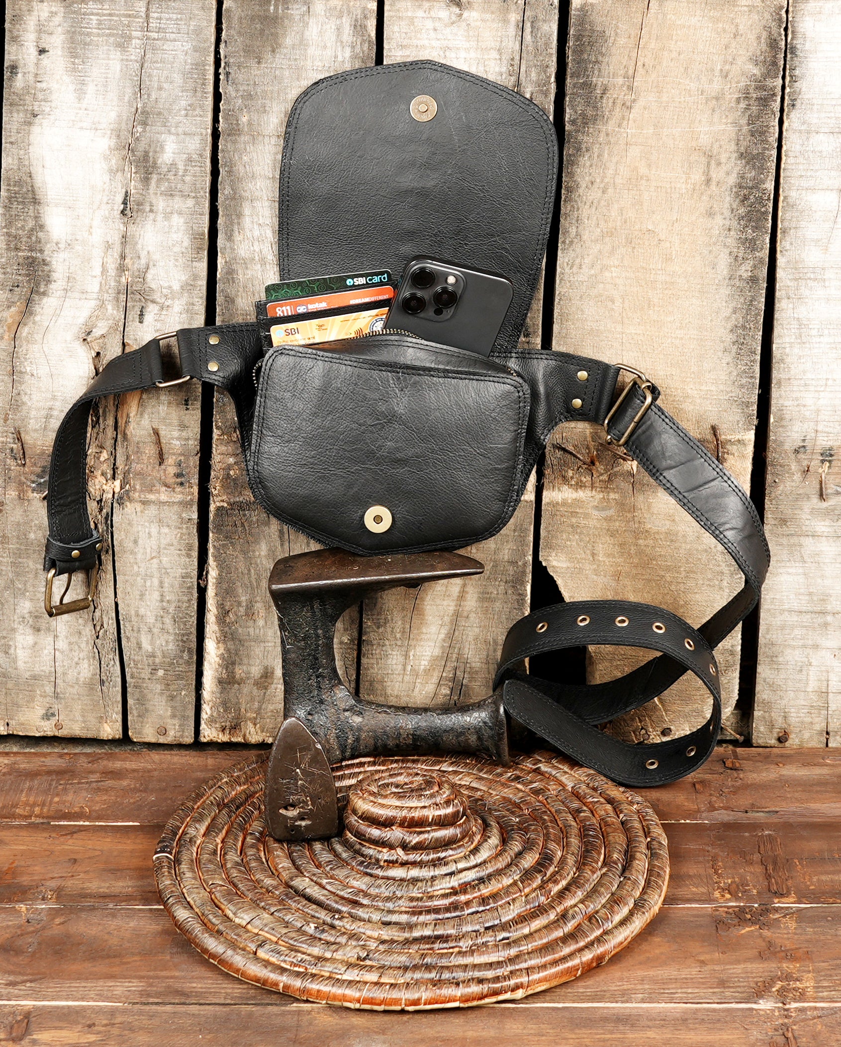 Classic black leather festival belt pouch with front flap and gold stud accents.