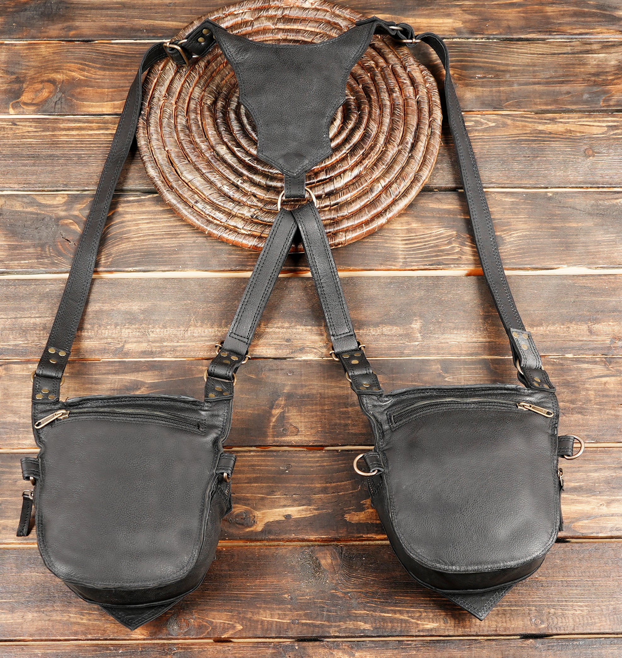 “Black leather chest rig with structured paneling and heavy-duty closures”