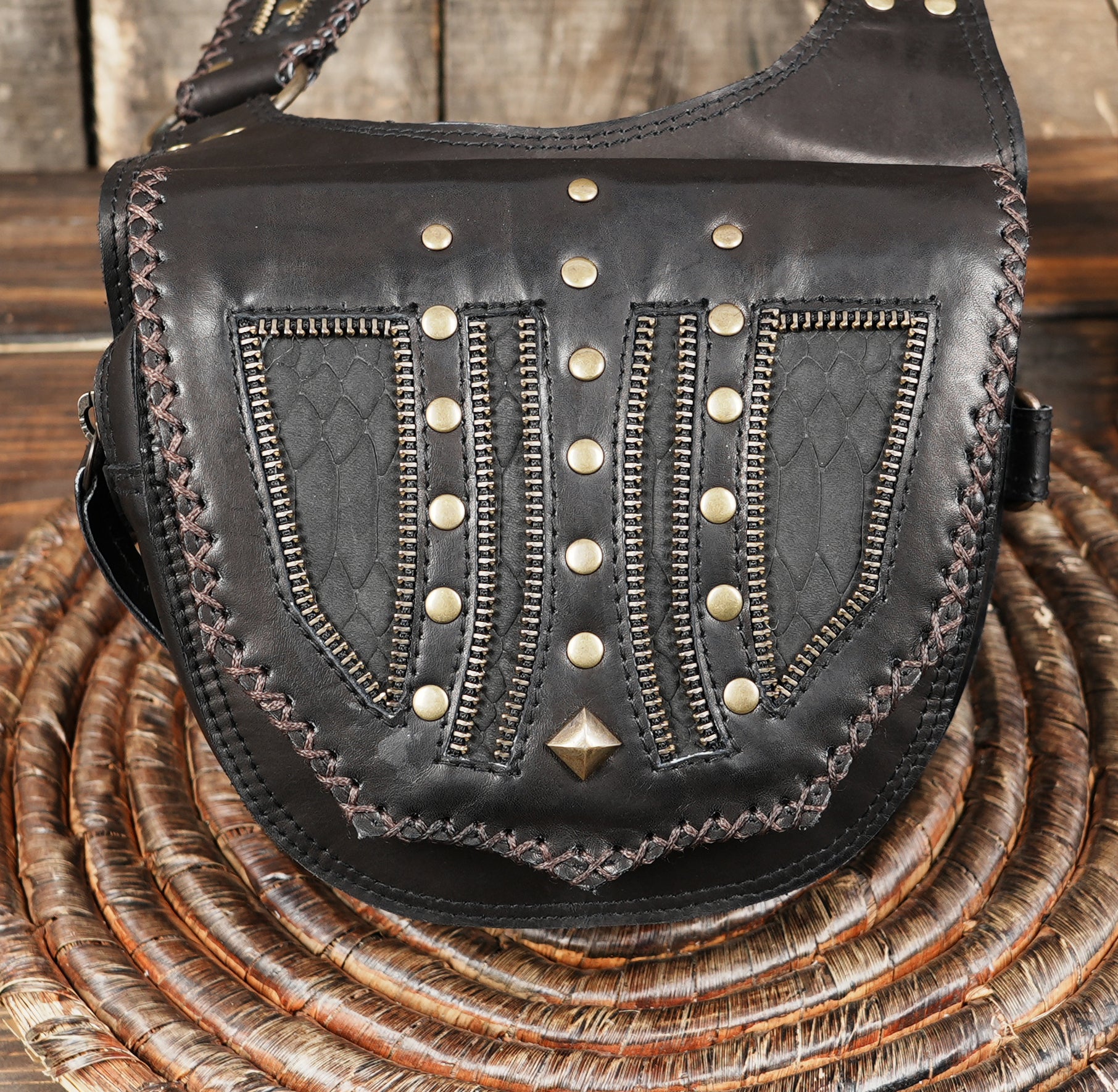 mannequin wearing leather harness holster bag across chest and waist