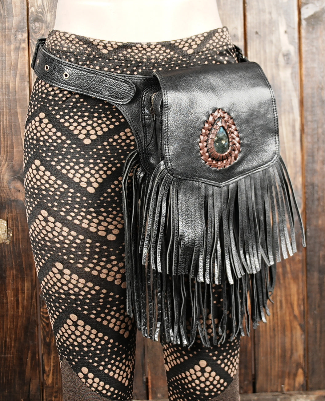 secure snap flap over gemstone accent on leather holster bag