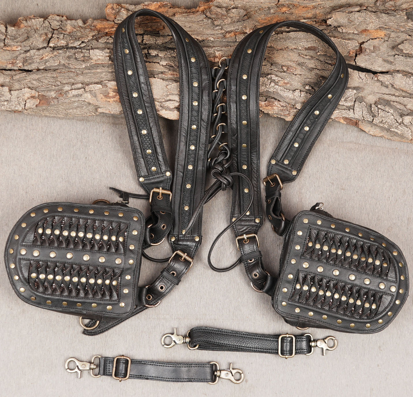 Black leather holster straps with adjustable buckles and clips