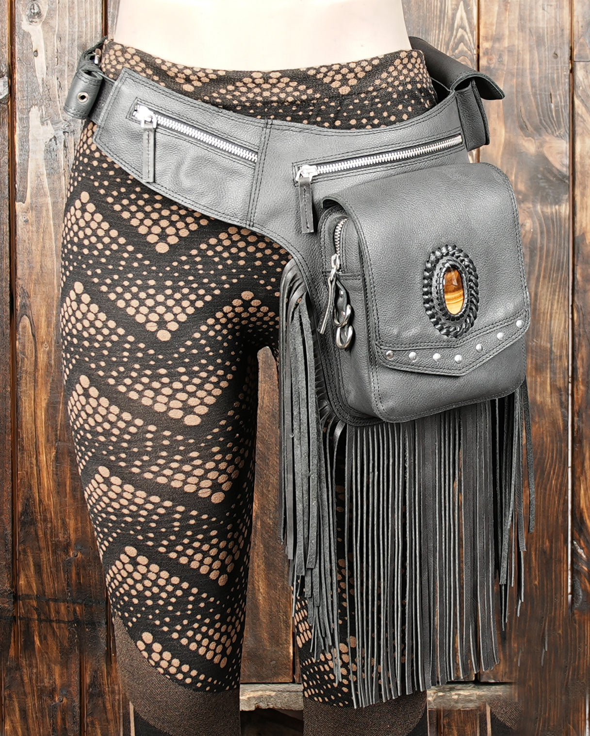 Black fringe fanny pack with gemstone front panel.