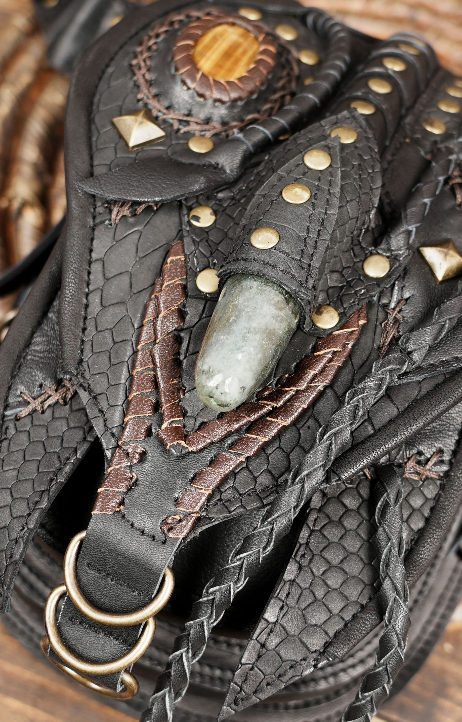 Western boho leather waist bag with intricate stitching and metal rivets