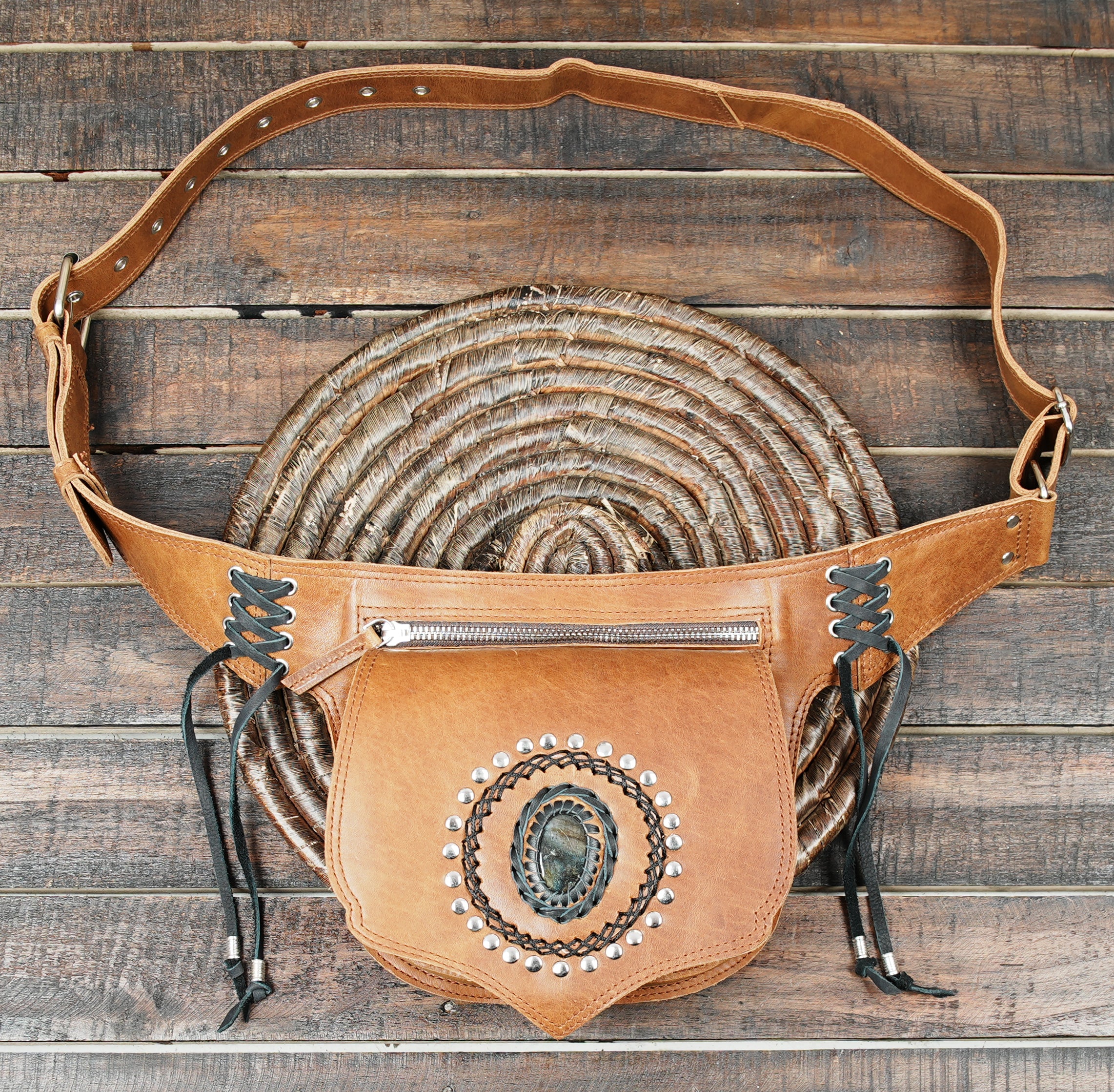 Steampunk-inspired leather belt bag with gemstone design and rustic stitching