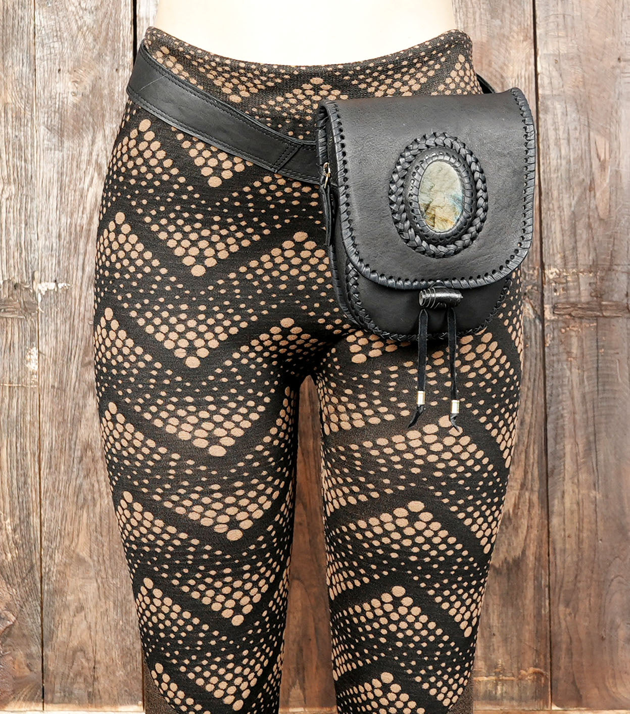 Close-up of stone accent on black leather waist pouch