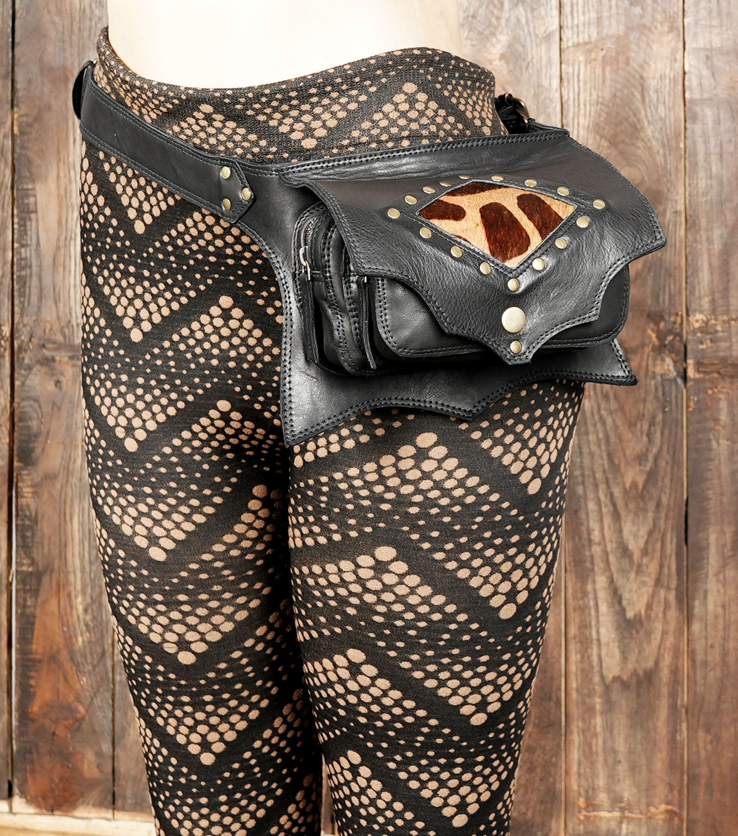 Back view of black leather belt bag with zipper pocket