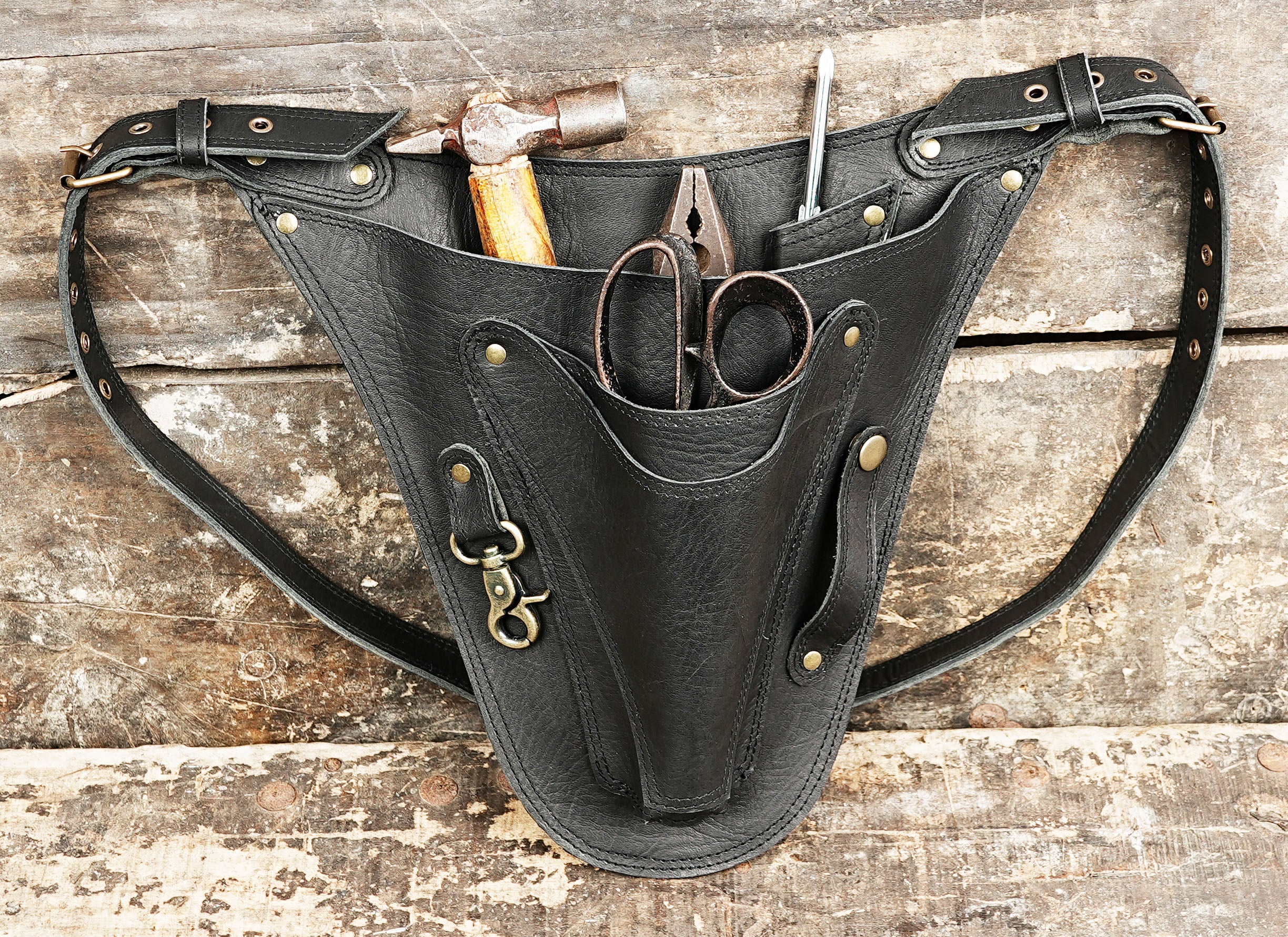 Craftsman style black leather waist bag with tool compartments