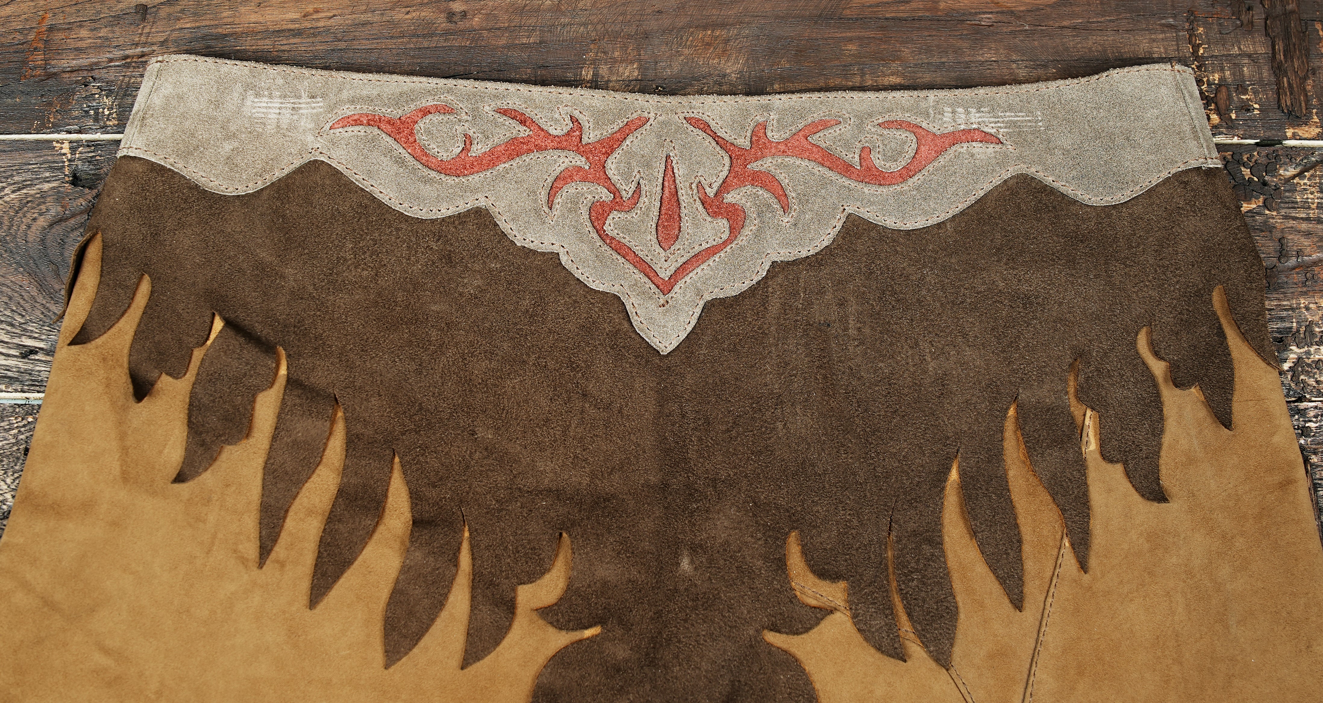 Rustic suede leather skirt with cowboy-style fringe and stitched pattern