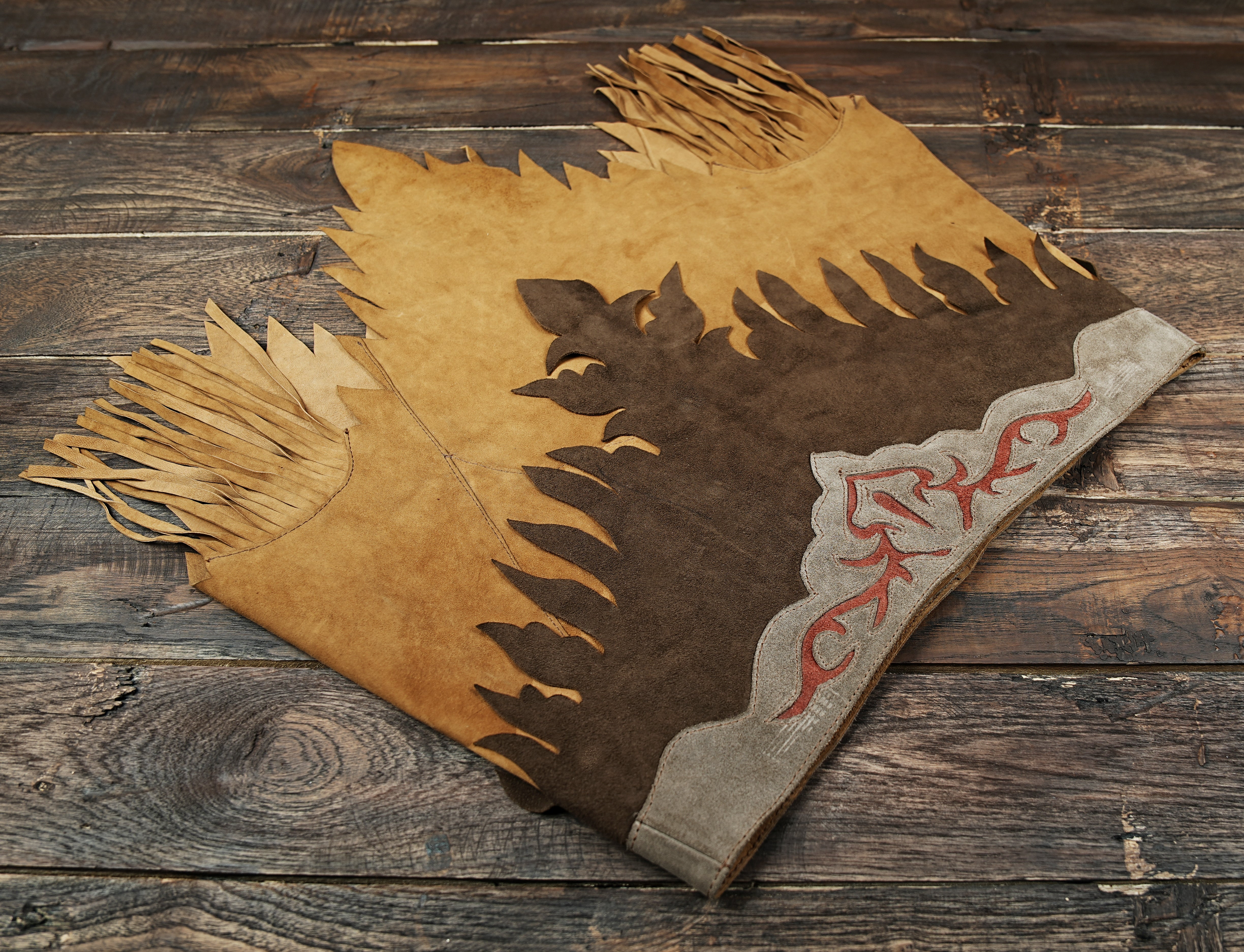 Rustic suede leather skirt with western-inspired details and fringe trim