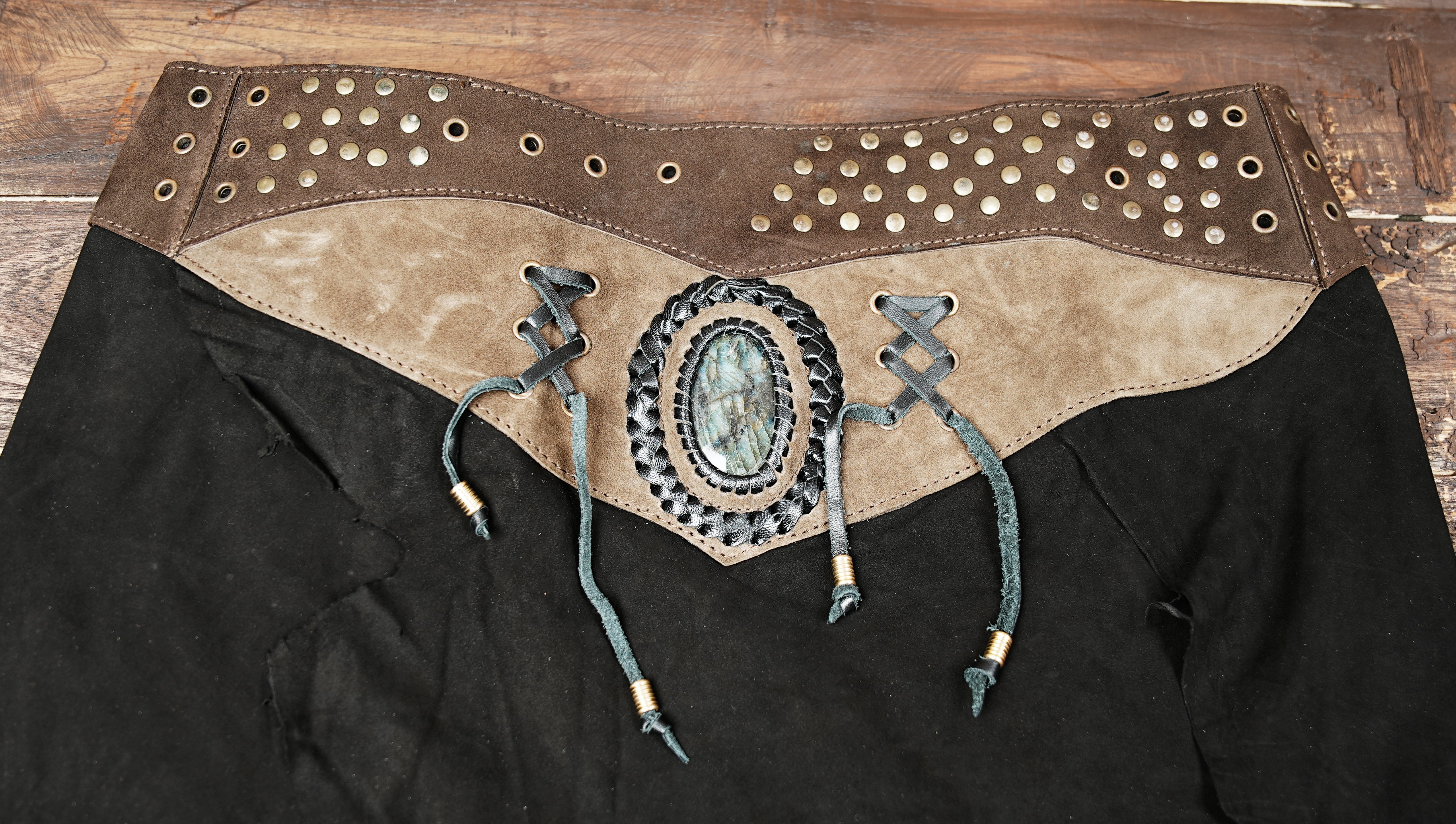 “Tribal gothic leather skirt with gemstone detail and rustic studs, perfect for cosplay and festivals.