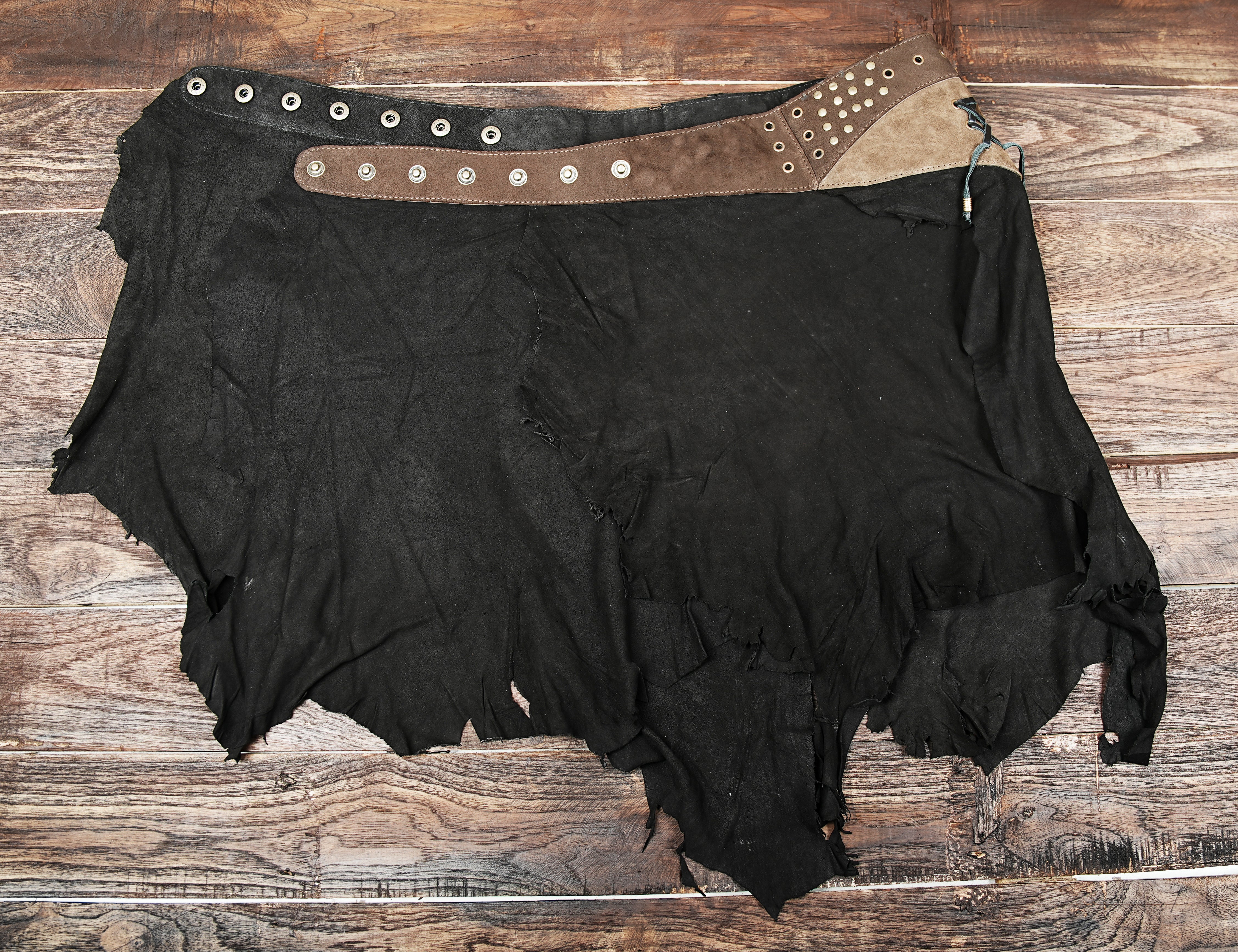 “Handmade leather skirt with gemstone and stud details, Burning Man festival outfit.”