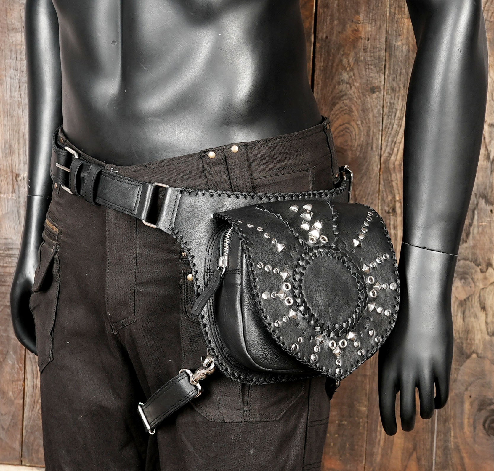 Adjustable waist and thigh straps on black leather leg holster bag