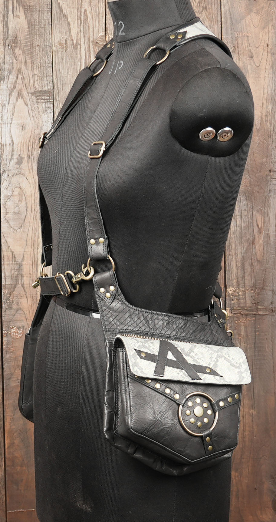 Unique tribal leather holster with antique brass fittings and artistic layout.