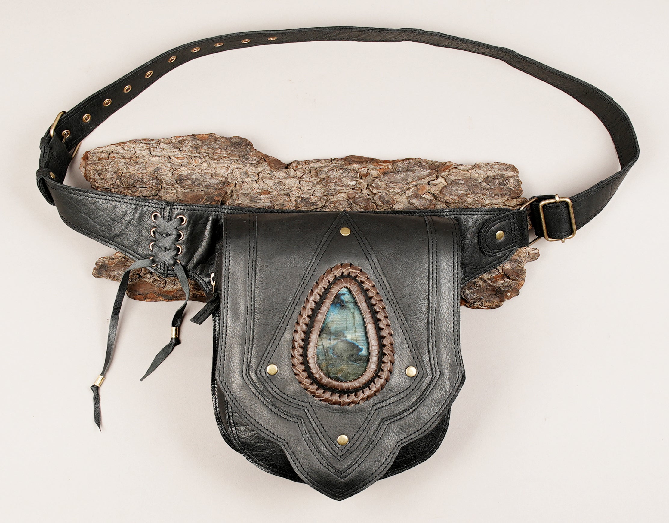 Artisan crafted leather waist bag with large center stone and layered panel design