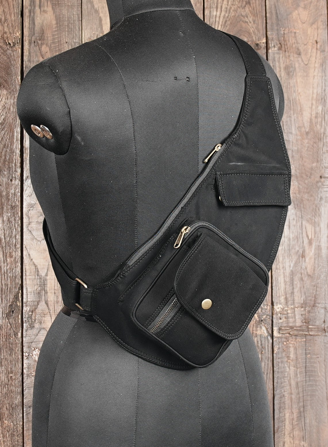 Cotton holster bag worn across the chest on a black mannequin torso