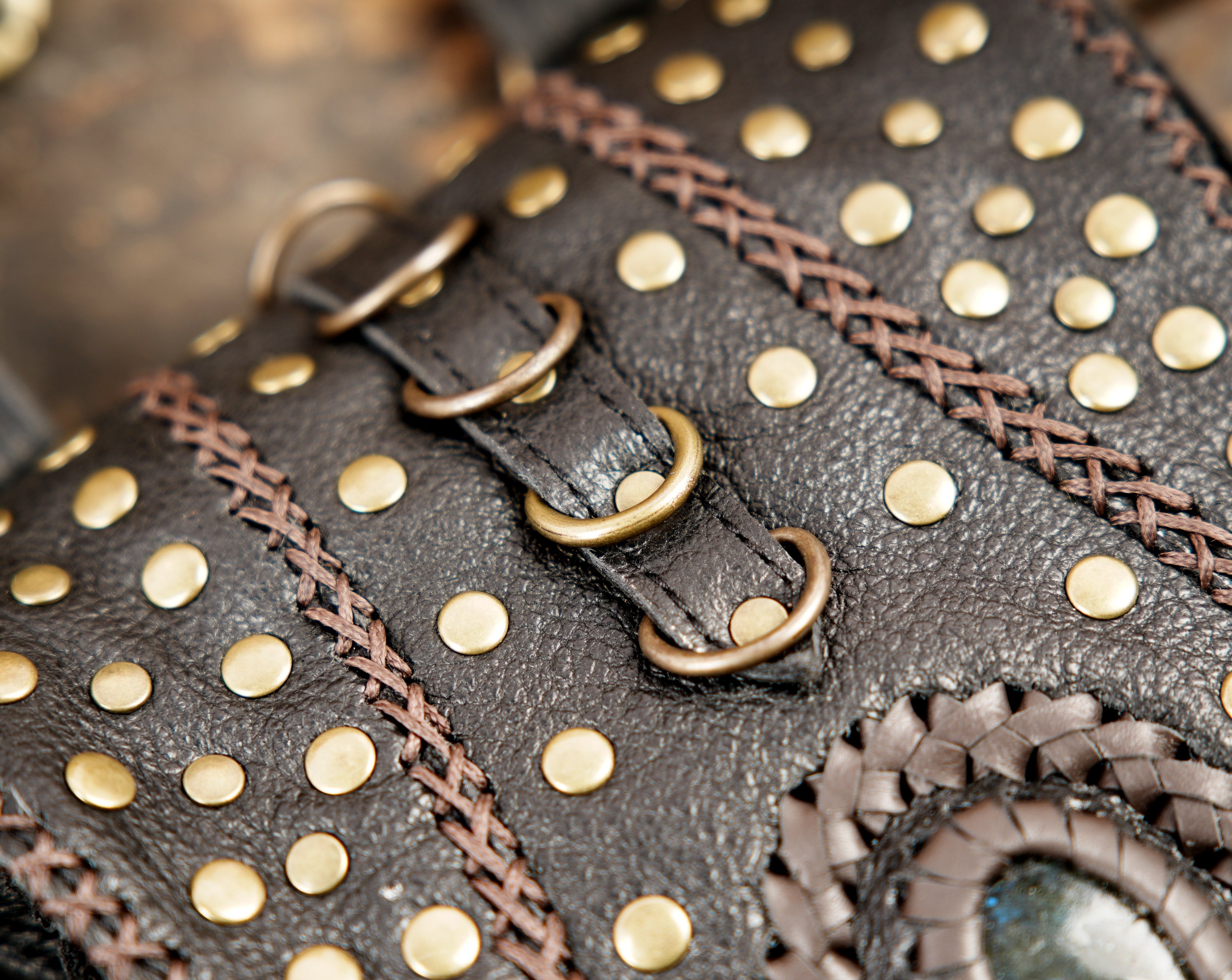 “Black leather shoulder holster with double pouches and rustic metal hardware”